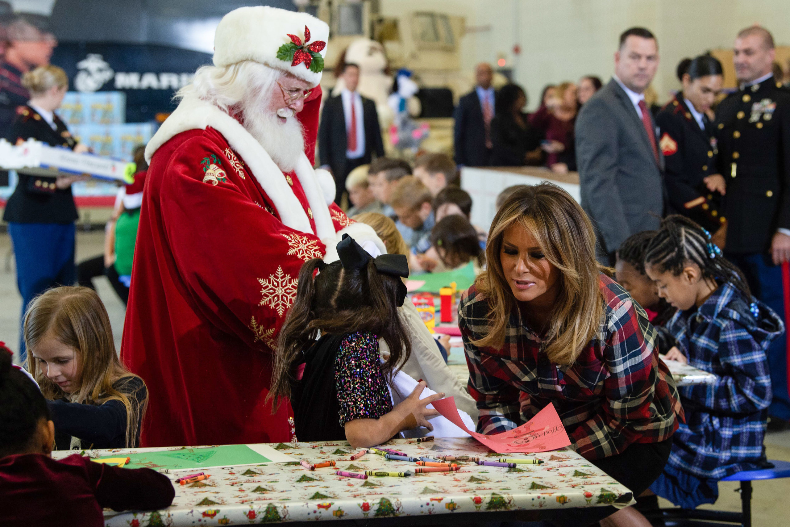 US First Lady Melania Trump attends with Father Christmas personificator a Toys for Tots event at Joint Base Anacostia-Bolling in Washington, DC, on December 11, 2018. - Toys for Tots is a program run by the United States Marine Corps Reserve which distributes toys to children whose parents cannot afford to buy them gifts for Christmas. (Photo by NICHOLAS KAMM / AFP) (Photo credit should read NICHOLAS KAMM/AFP via Getty Images)