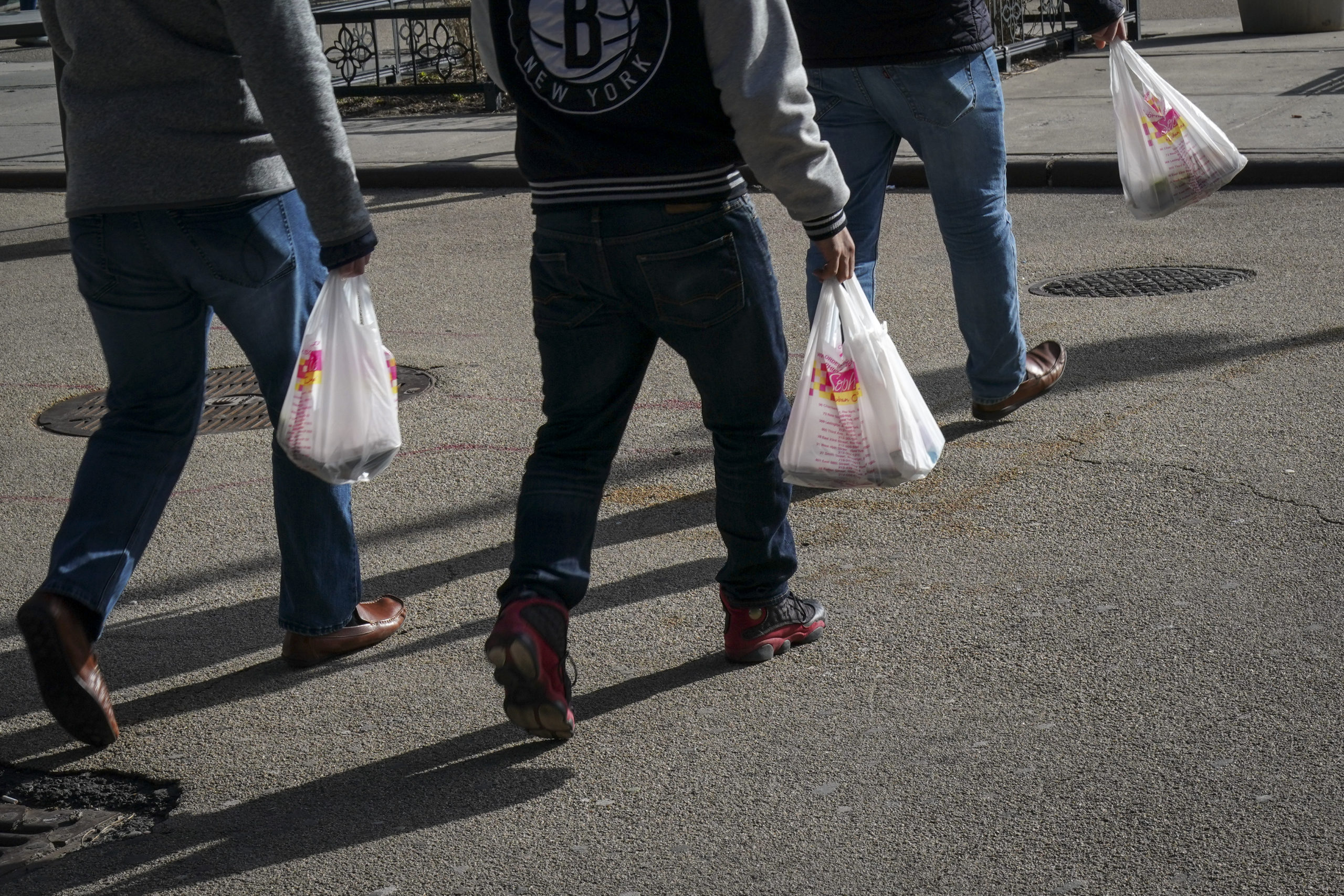 People carry plastic bags in 2019. (Drew Angerer/Getty Images)