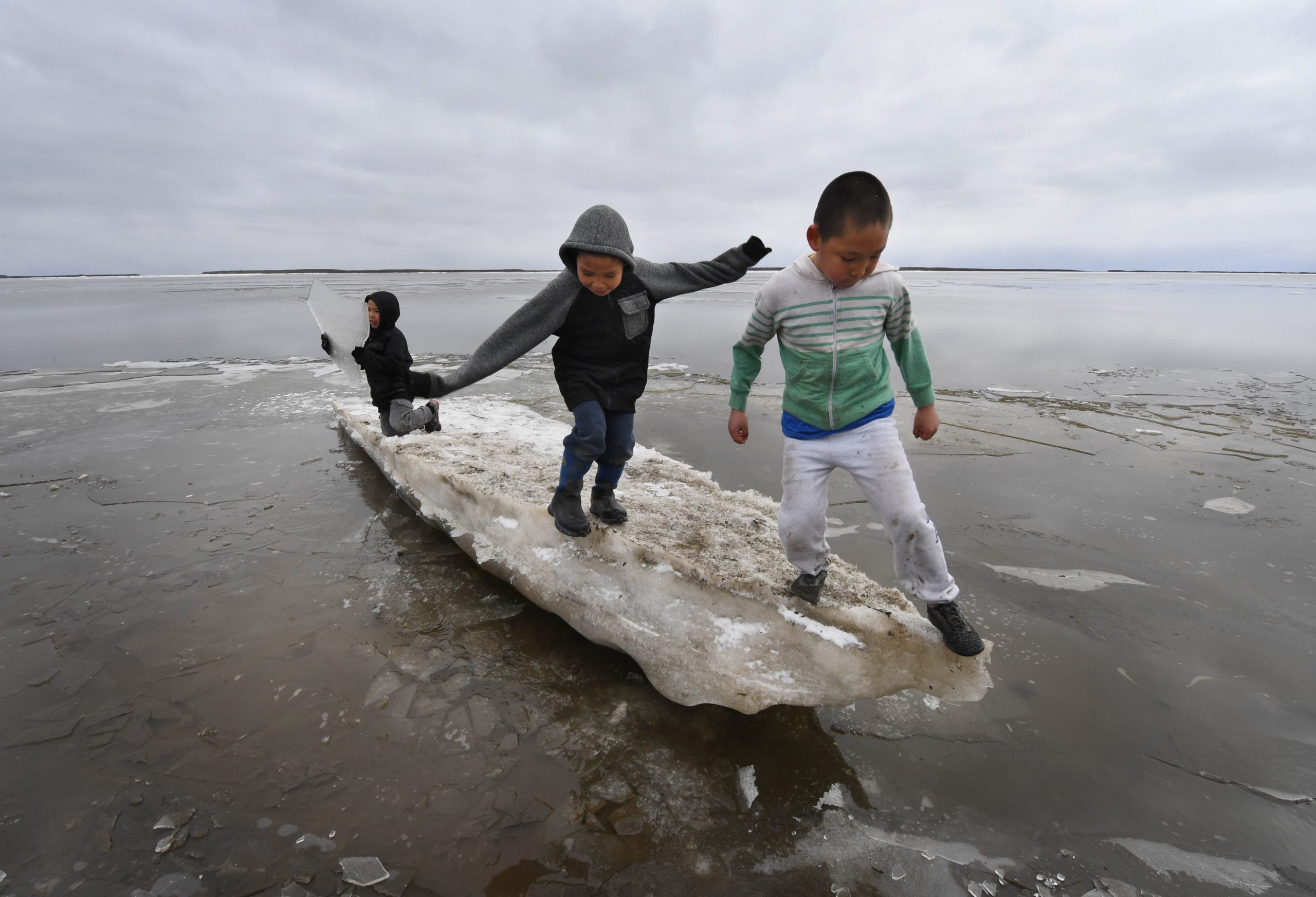 Schoolchildren play on melting ice at the Yupik Eskimo village of Napakiak on the Yukon Delta in Alaska on April 18, 2019. (Mark Ralston/AFP via Getty Images)