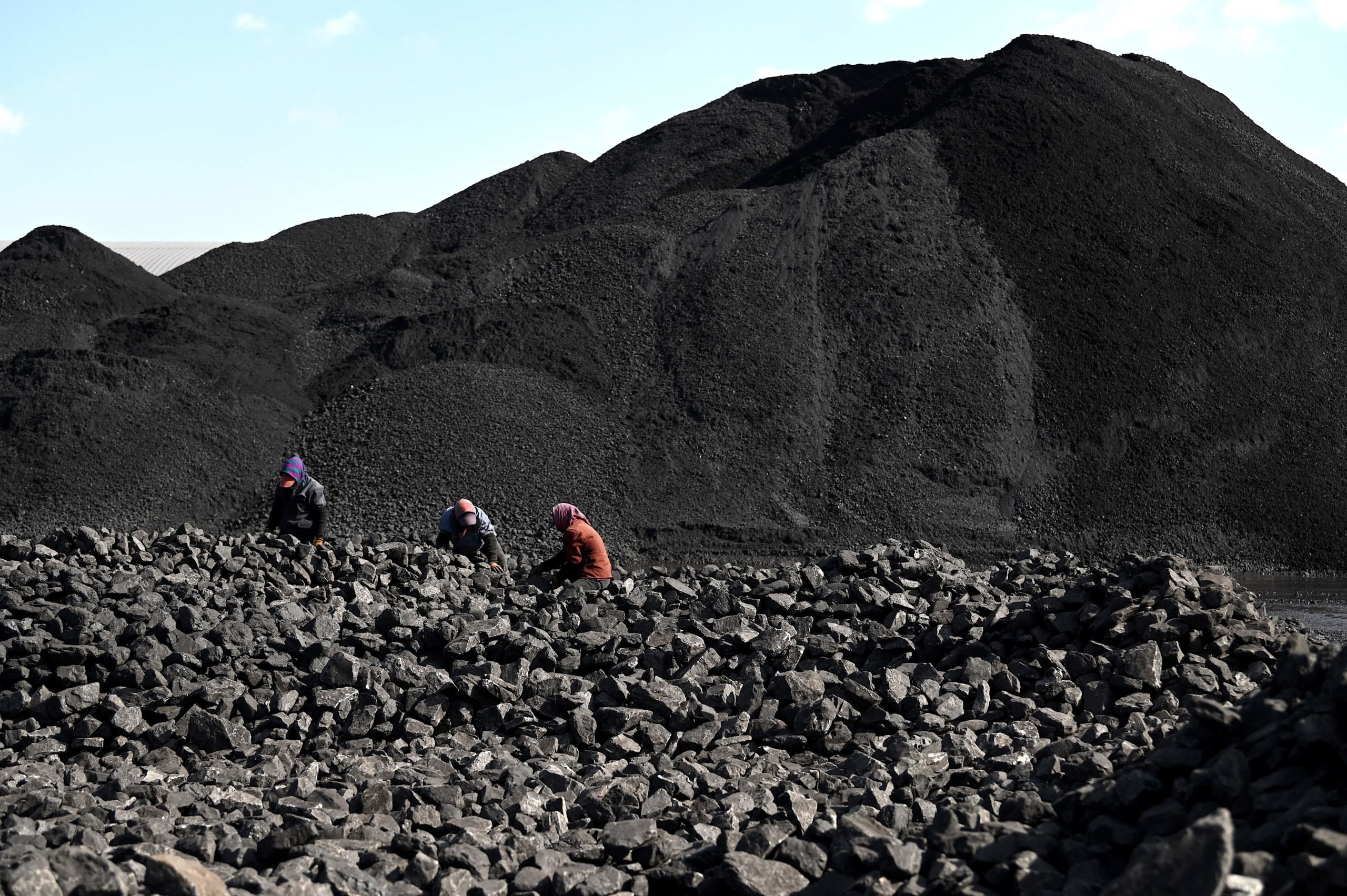 Workers sort coal near a coal mine in Datong, China's northern Shanxi province on Nov. 3. (Noel Celis/AFP via Getty Images)