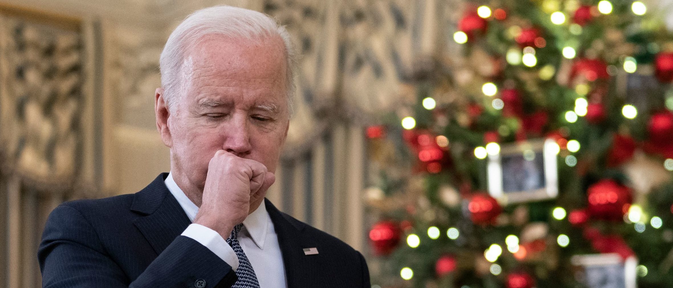 President Joe Biden coughs as he talks to reporters about the November Jobs Report on Friday. (Andrew Caballero-Reynolds/AFP via Getty Images)