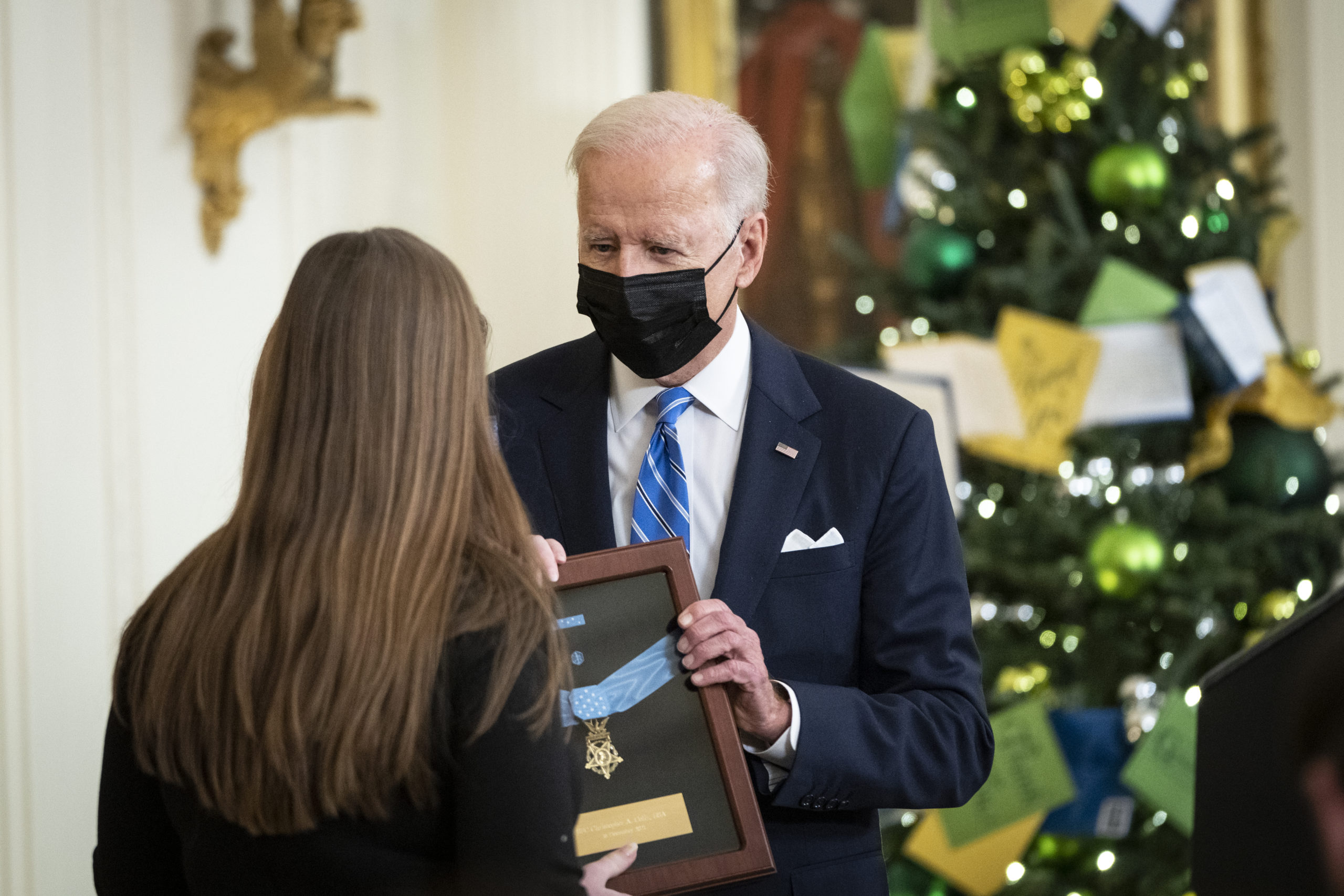 WASHINGTON, DC - DECEMBER 16: Katherine Celiz (L), widow of the late Sgt. 1st Class Christopher Celiz, accepts the Medal of Honor on his behalf from U.S. President Joe Biden during a ceremony in the East Room of the White House December 16, 2021 in Washington, DC. Sgt. Celiz was an Army Ranger and died fighting the Taliban in Afghanistan in 2018. He took on Taliban fighters to protect a helicopter that was carrying out a medical evacuation.(Photo by Drew Angerer/Getty Images)