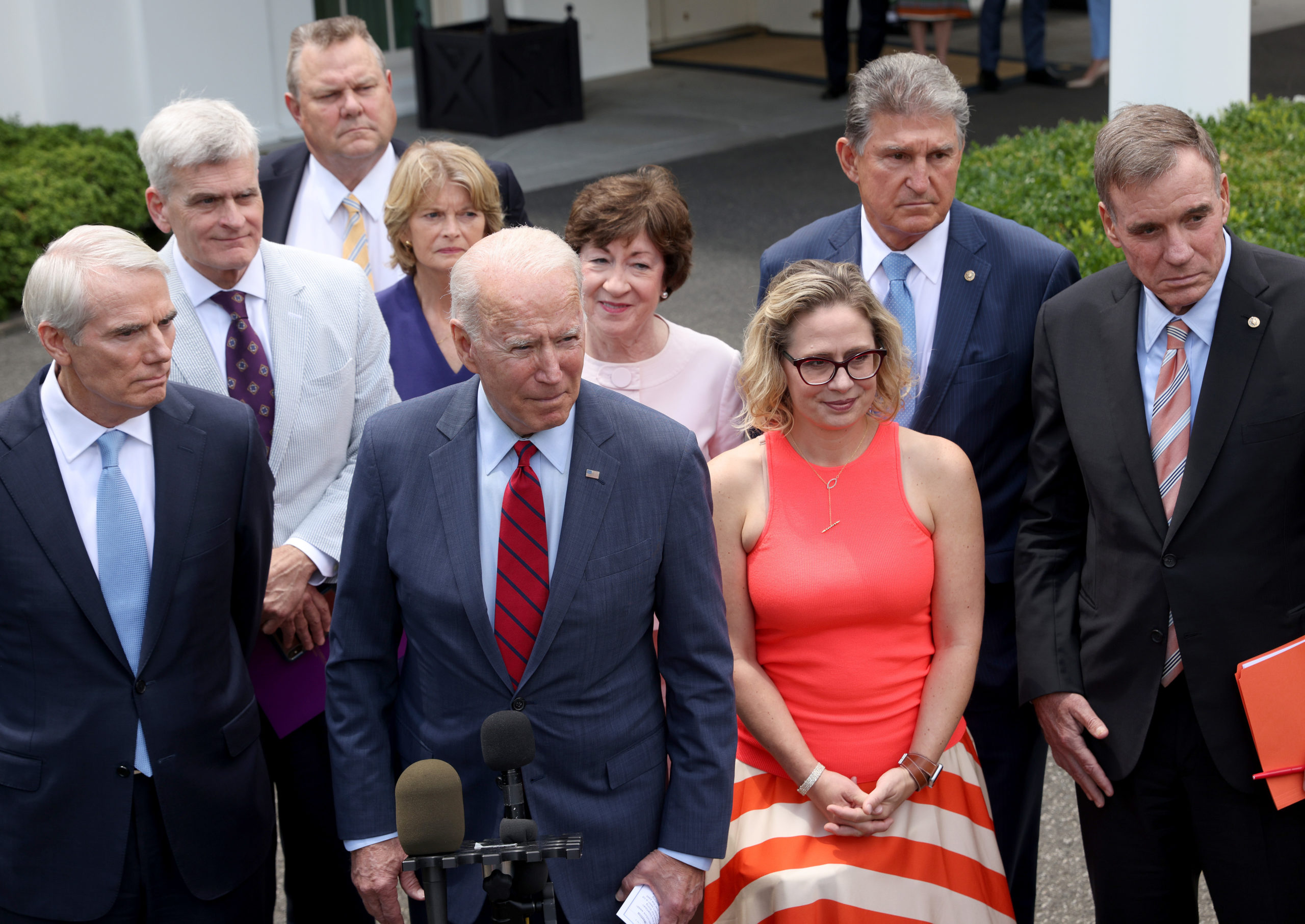 WASHINGTON, DC - JUNE 24: U.S. President Joe Biden speaks outside the White House with a bipartisan group of senators after meeting on an infrastructure deal June 24, 2021 in Washington, DC. From left to right are Sen. Rob Portman (R-OH), Sen. Bill Cassidy (R-LA), Sen. Jon Tester (D-MT), Sen. Lisa Murkowski (R-AK), Sen. Susan Collins (R-ME), Sen. Kyrsten Sinema (D-AZ), Sen. Joe Manchin (D-WV), and Sen. Mark Warner (D-VA). Biden indicated that a framework for an infrastructure bill is in place following the meeting. (Photo by Win McNamee/Getty Images)