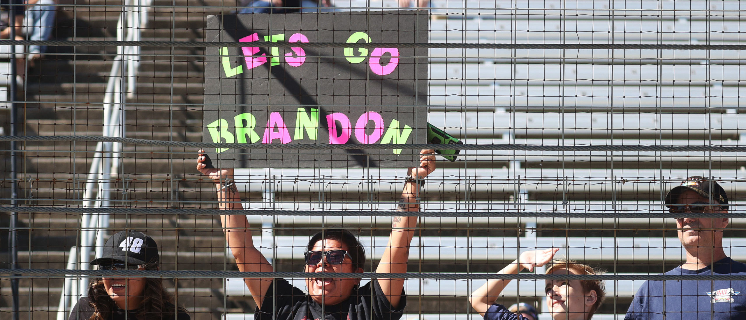 FORT WORTH, TEXAS - OCTOBER 16: A NASCAR fan hols a "Lets Go Brandon" sign during the NASCAR Xfinity Series Andy's Frozen Custard 335 at Texas Motor Speedway on October 16, 2021 in Fort Worth, Texas. (Photo by Chris Graythen/Getty Images)