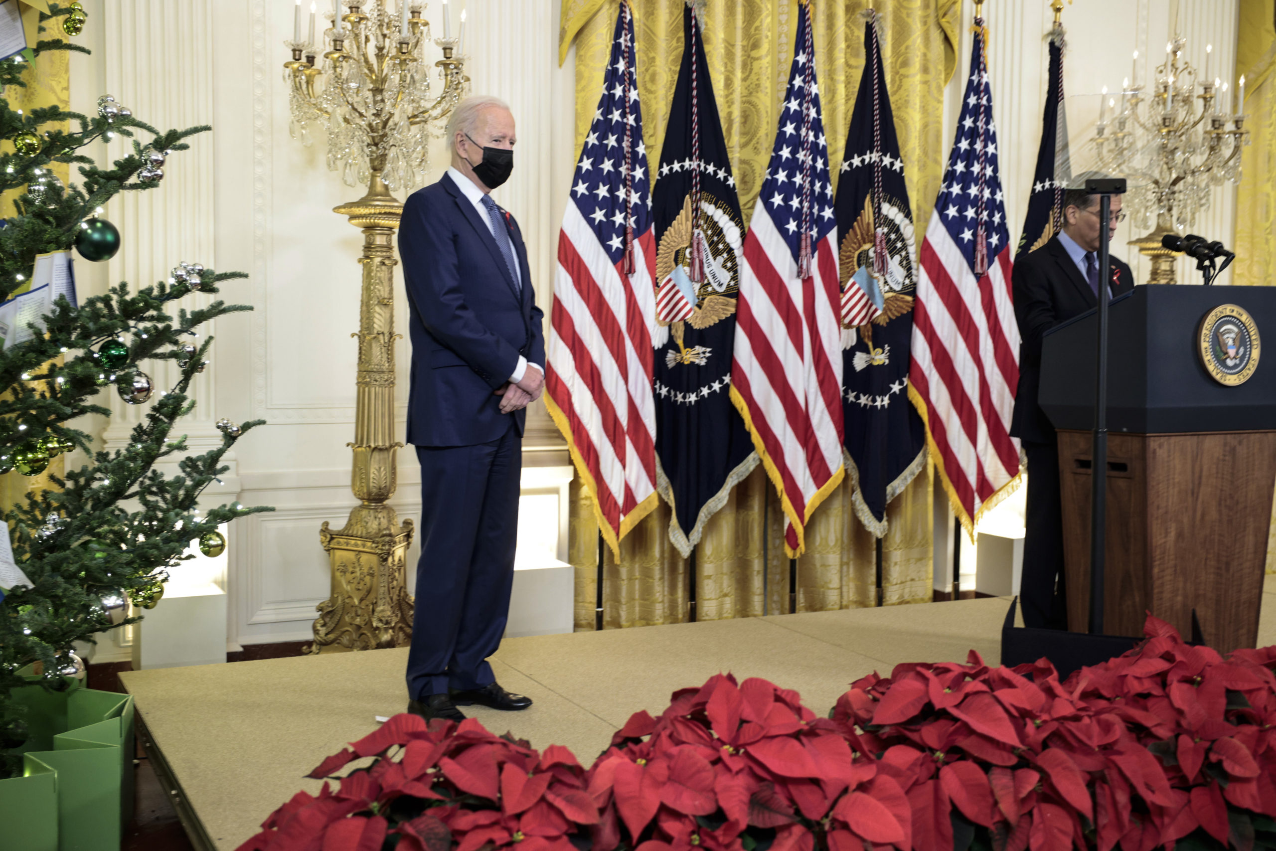 President Joe Biden listens as Health Secretary Xavier Becerra delivers remarks at the White House on Dec. 1. (Anna Moneymaker/Getty Images)