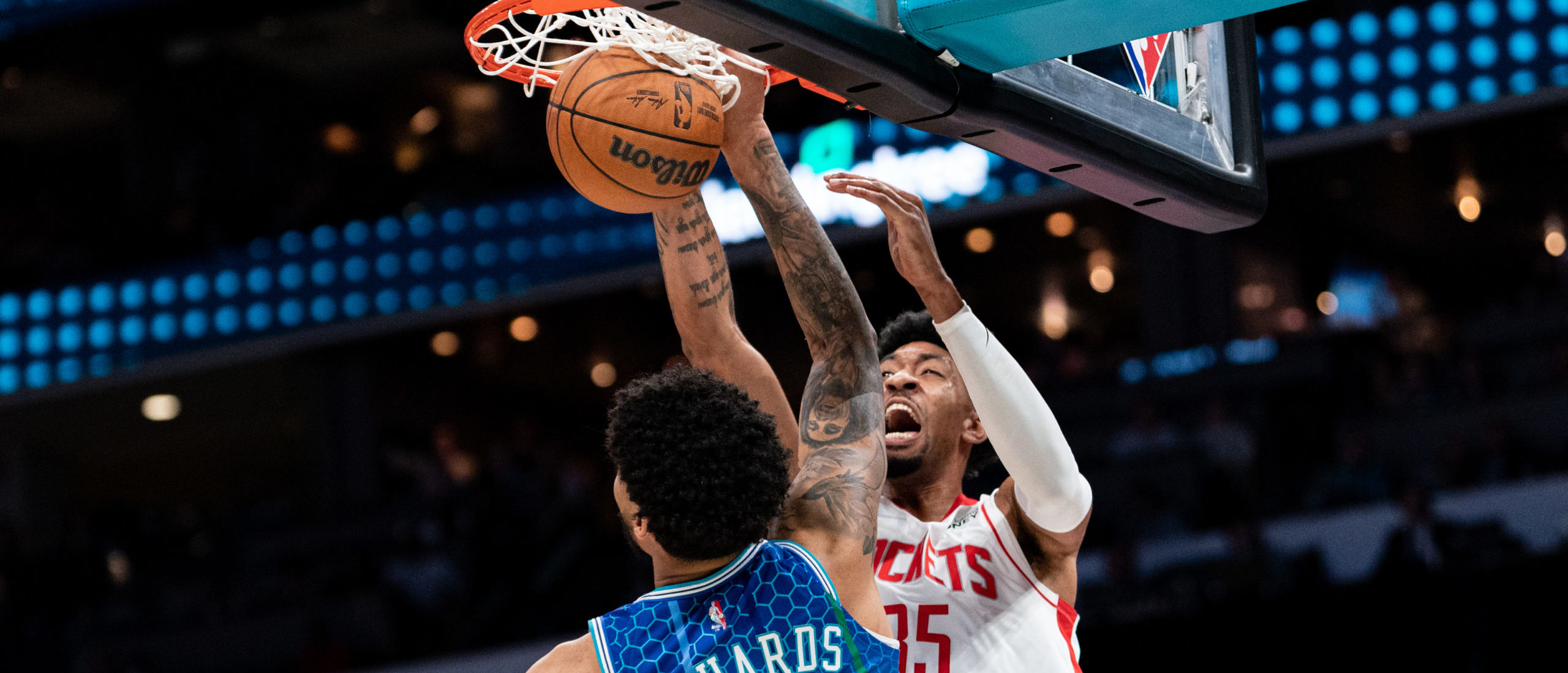 CHARLOTTE, NORTH CAROLINA - DECEMBER 27: Christian Wood #35 of the Houston Rockets dunks the ball over Nick Richards #14 of the Charlotte Hornets in the first quarter during their game at Spectrum Center on December 27, 2021 in Charlotte, North Carolina. NOTE TO USER: User expressly acknowledges and agrees that, by downloading and or using this photograph, User is consenting to the terms and conditions of the Getty Images License Agreement. (Photo by Jacob Kupferman/Getty Images)