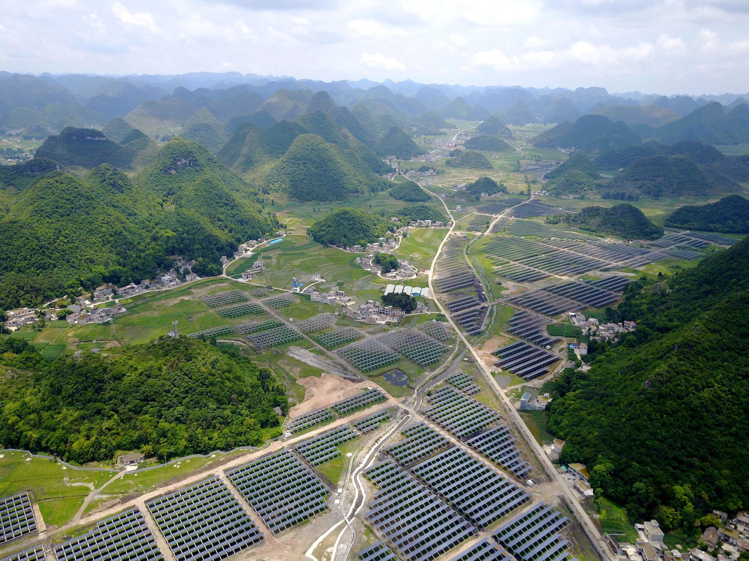 This photo taken on June 10, 2017 shows greenhouses built with solar panels on their roofs in China's southwest Guizhou province. (STR/AFP via Getty Images)