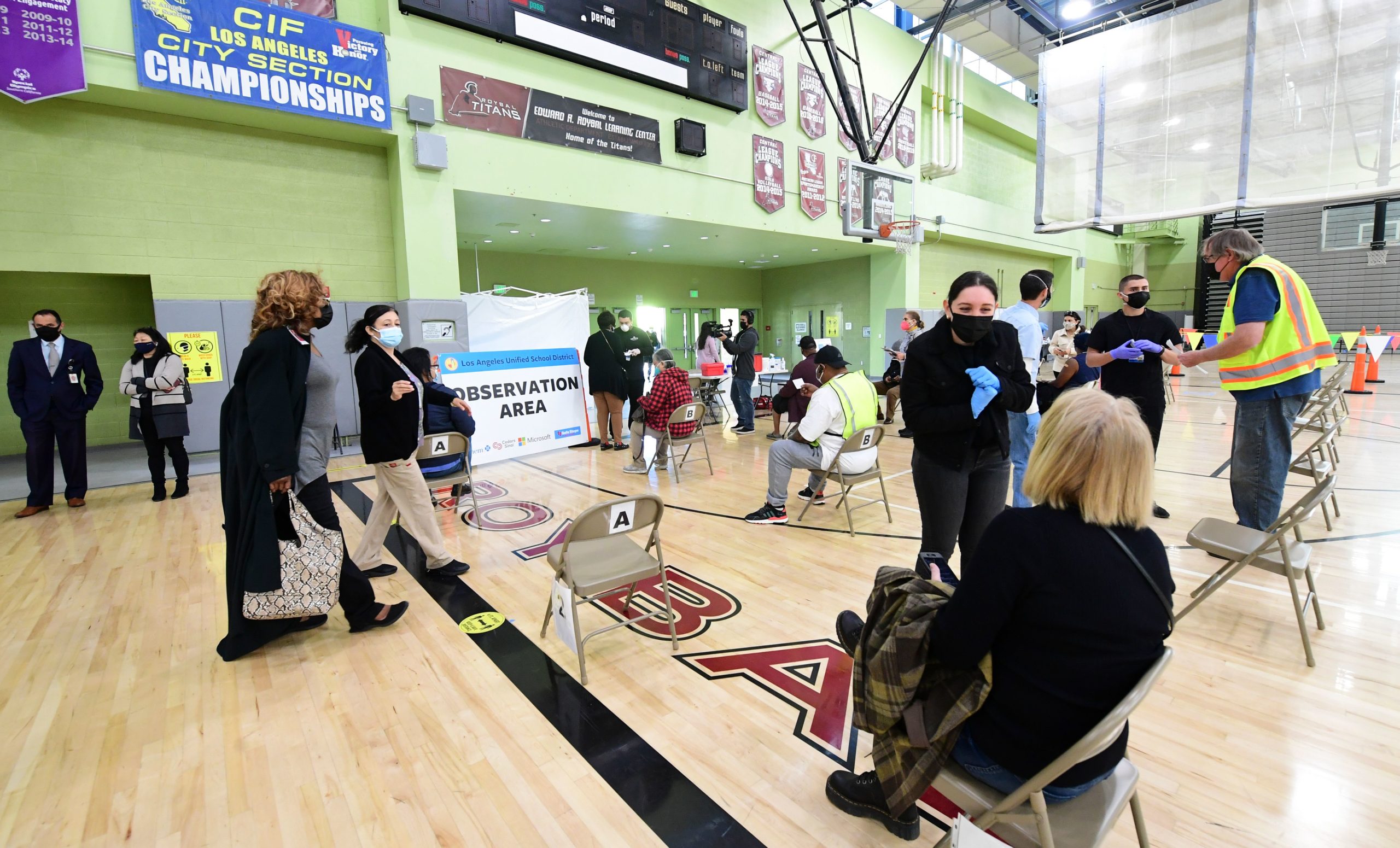 People sit in a waiting area for observation following their Covid-19 vaccinations at a site opened today by the Los Angeles Unified School District (LAUSD) for LAUSD employees on February 17, 2021 in Los Angeles. (Photo by FREDERIC J. BROWN/AFP via Getty Images)