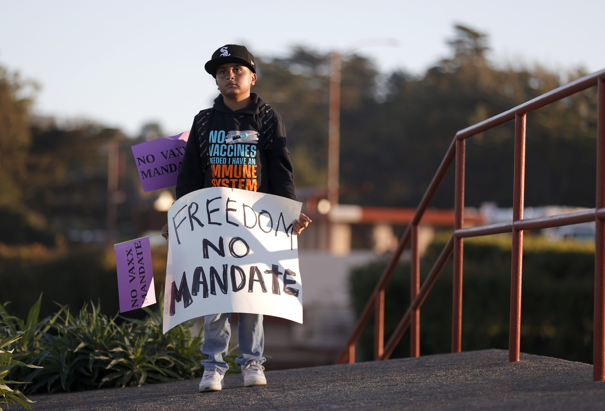 A young boy holds a sign during an anti-vaccination rally at the Golden Gate Bridge on November 11, 2021 in San Francisco, California. Protesters against the COVID-19 vaccination gathered at the Golden Gate Bridge to rally against vaccine mandates. (Photo by Justin Sullivan/Getty Images)