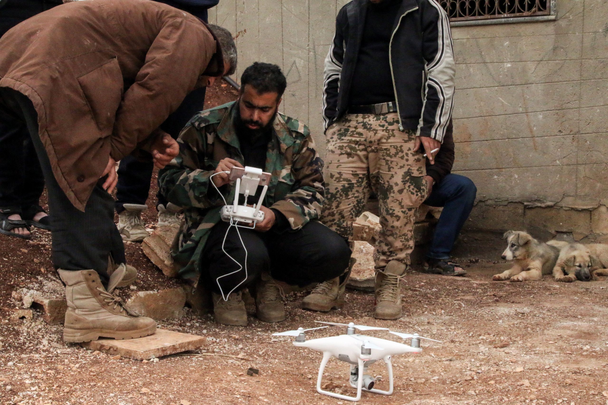 A Syrian rebel fighter operates a DJI Phantom 4 camera drone near the central Syrian rebel-held town of Talbiseh, in the countryside of the central Syrian district of Homs, on April 12, 2017. / AFP PHOTO / MAHMOUD TAHA (Photo credit should read MAHMOUD TAHA/AFP via Getty Images)