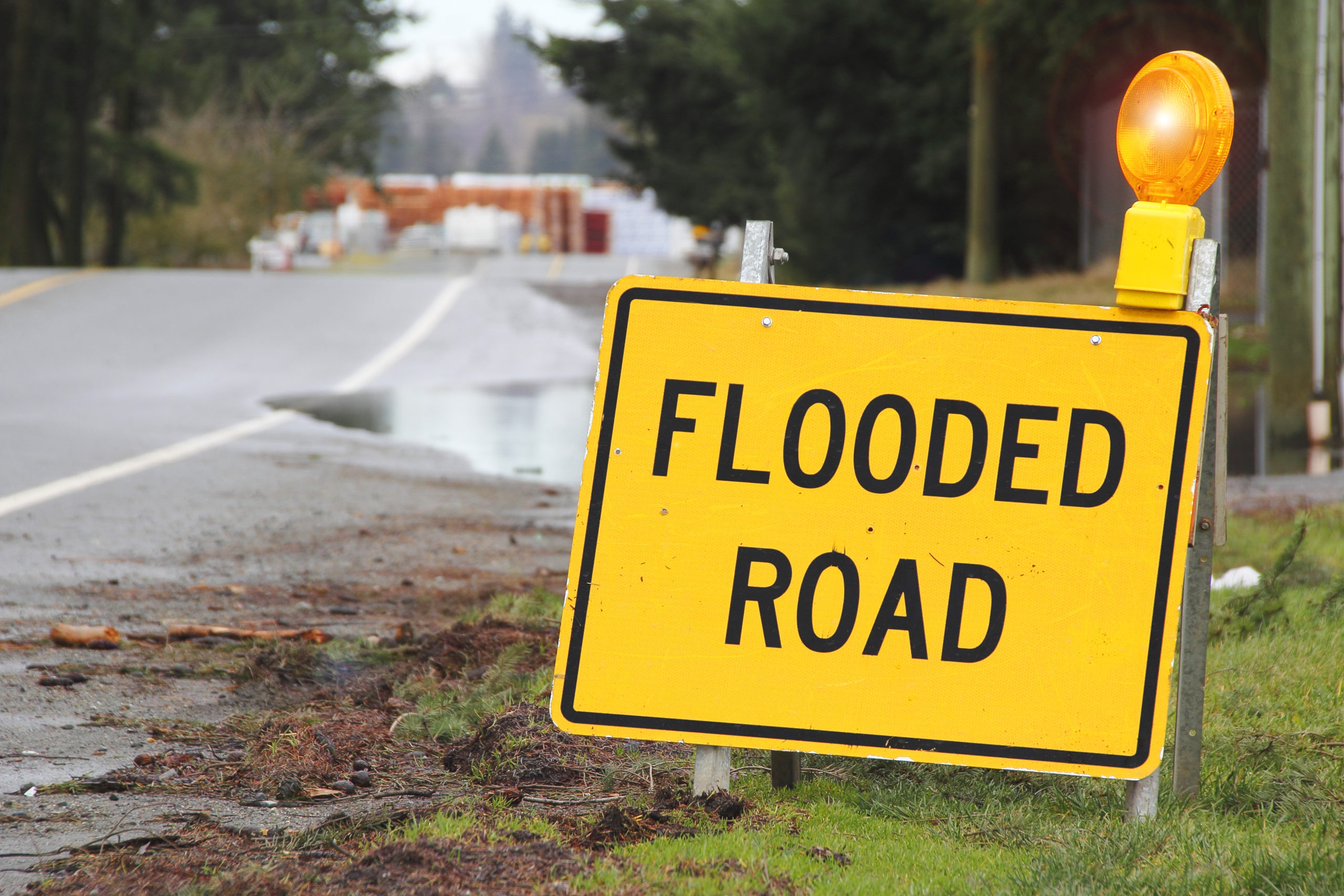 Warning sign for a flooded road [Shutterstock/Eric Buermeyer]