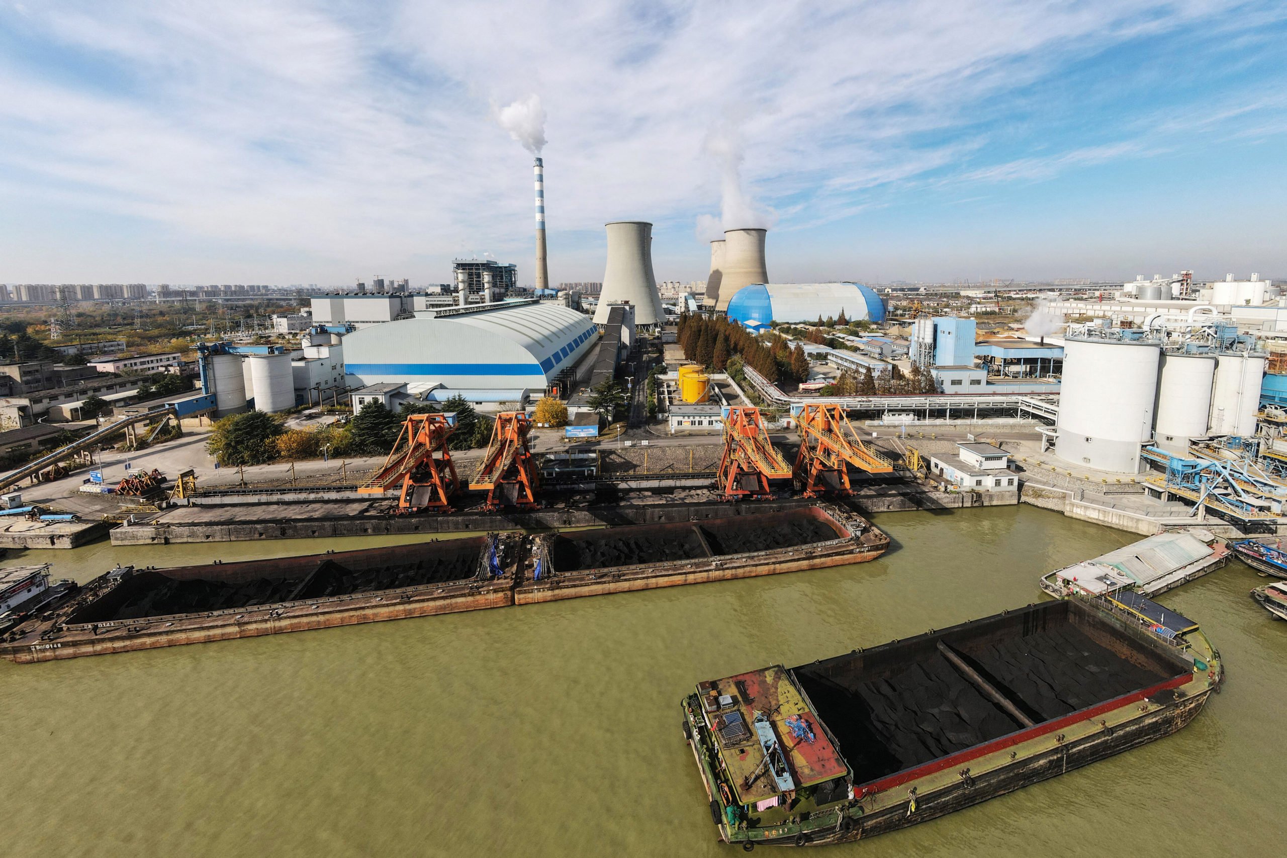 A barge unloads coal at a power station in Yangzhou, China on Nov. 23. - China OUT (STR/AFP via Getty Images)