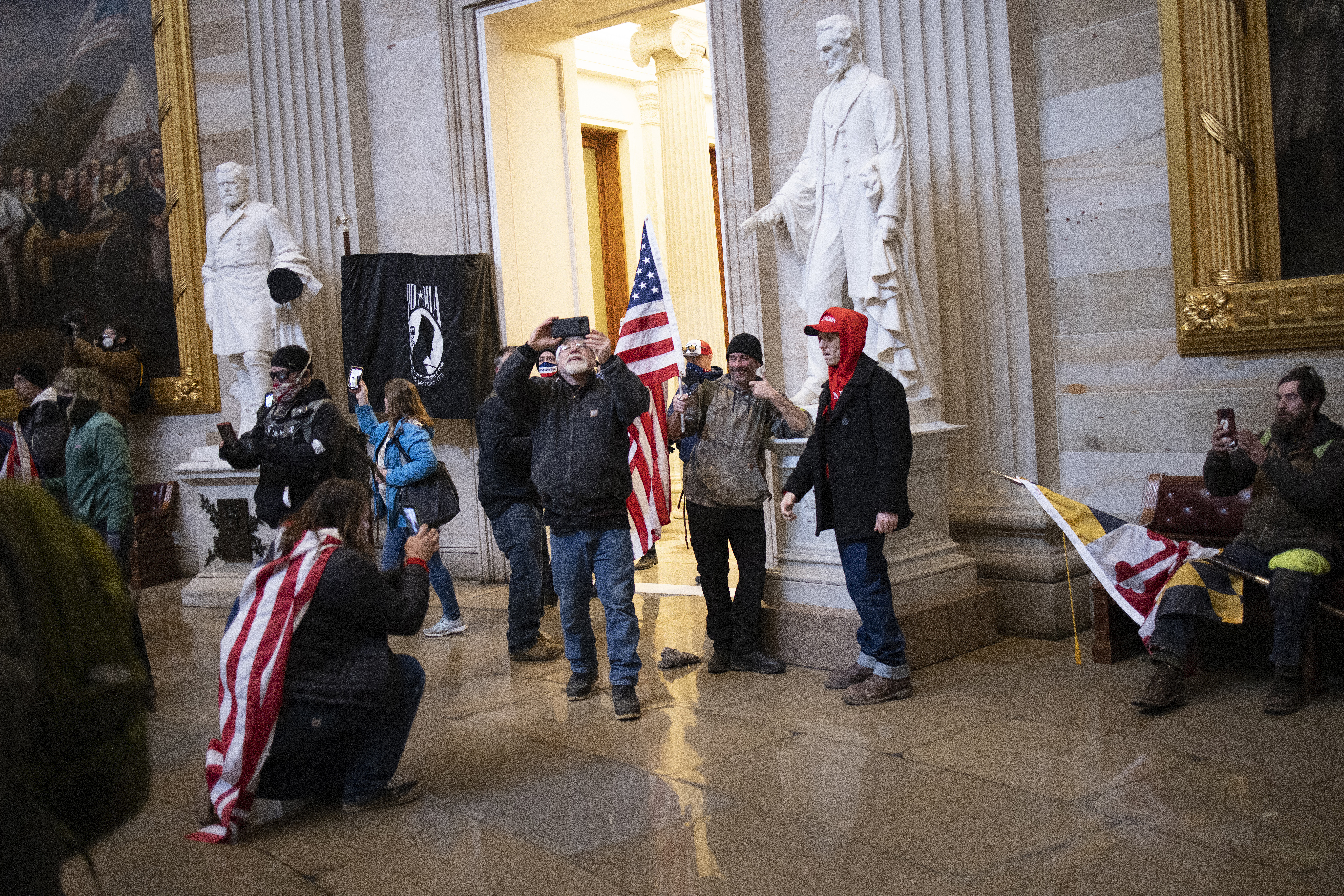 WASHINGTON, DC - JANUARY 06: Protesters supporting U.S. President Donald Trump gather gather in the Rotunda of the U.S. Capitol after groups breached the building's security on January 06, 2021 in Washington, DC. Pro-Trump protesters entered the U.S. Capitol building during demonstrations in the nation's capital. (Photo by Win McNamee/Getty Images)