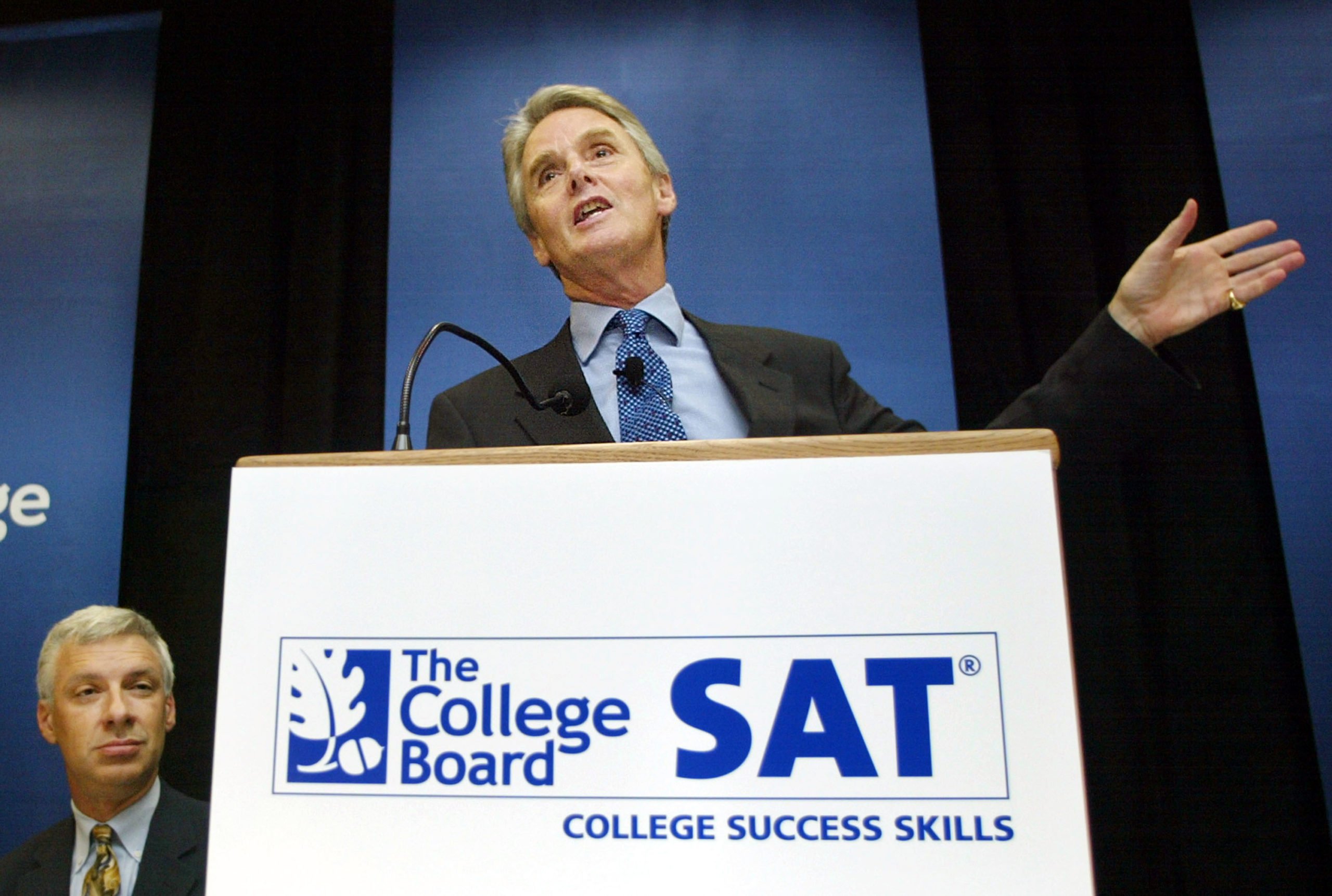 College Board President Gaston Caperton speaks at a press conference as Dr. Wayne Camara, vice president of research and development, looks on at College Board headquarters June 27, 2002 in New York City. College Board trustees decided June 27 to add a written essay and other changes to the SAT in an overhaul of the college entrance exam. The first administration of the new SAT will occur in March of 2005. (Photo by Mario Tama/Getty Images)