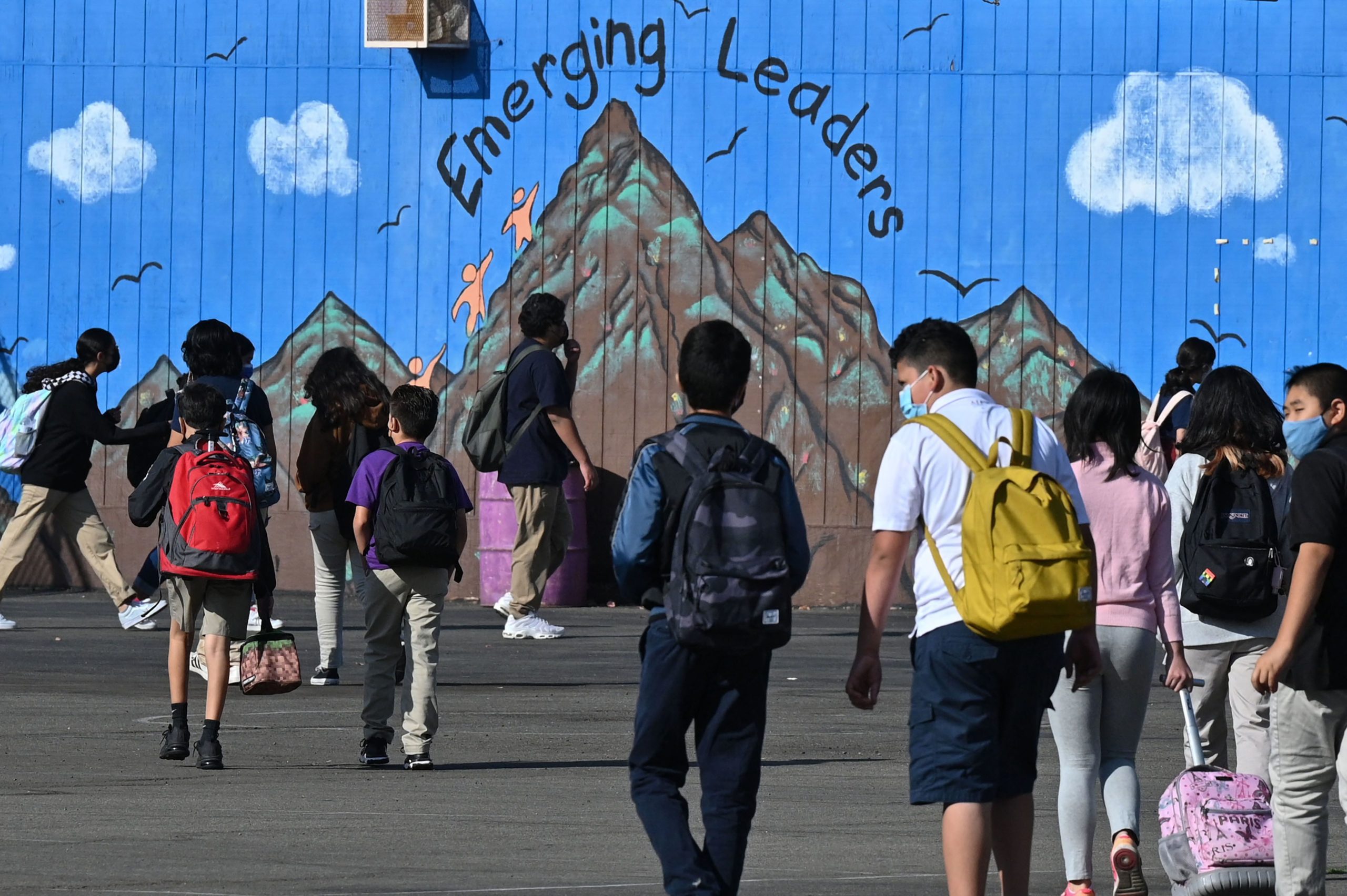 Students walk to their classrooms at a public middle school in Los Angeles, California, September 10, 2021. (Photo by ROBYN BECK/AFP via Getty Images)