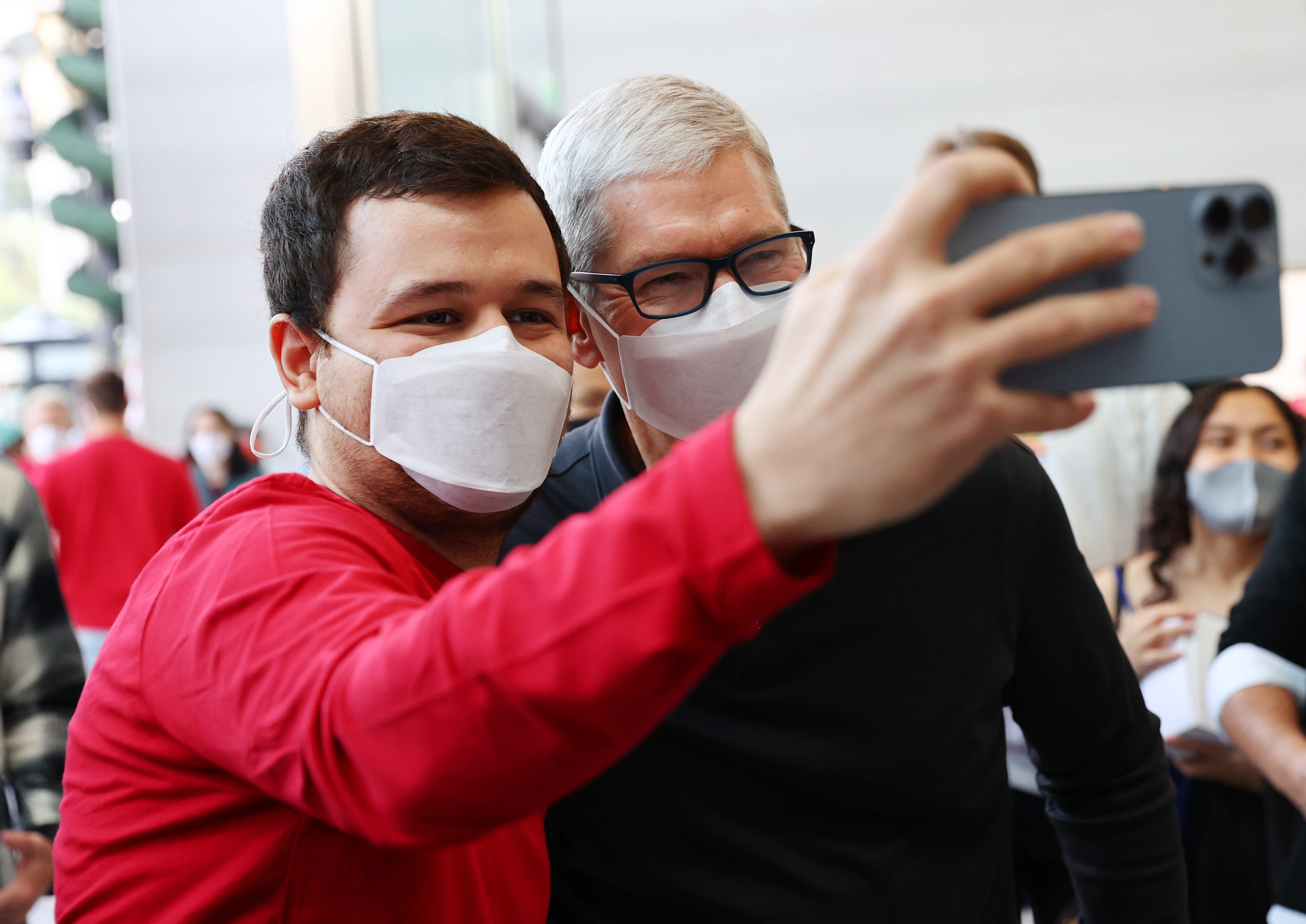Apple CEO Tim Cook (R) poses for a selfie with a person at the grand opening event for the new Apple store at The Grove on November 19, 2021 in Los Angeles, California. (Photo by Mario Tama/Getty Images)