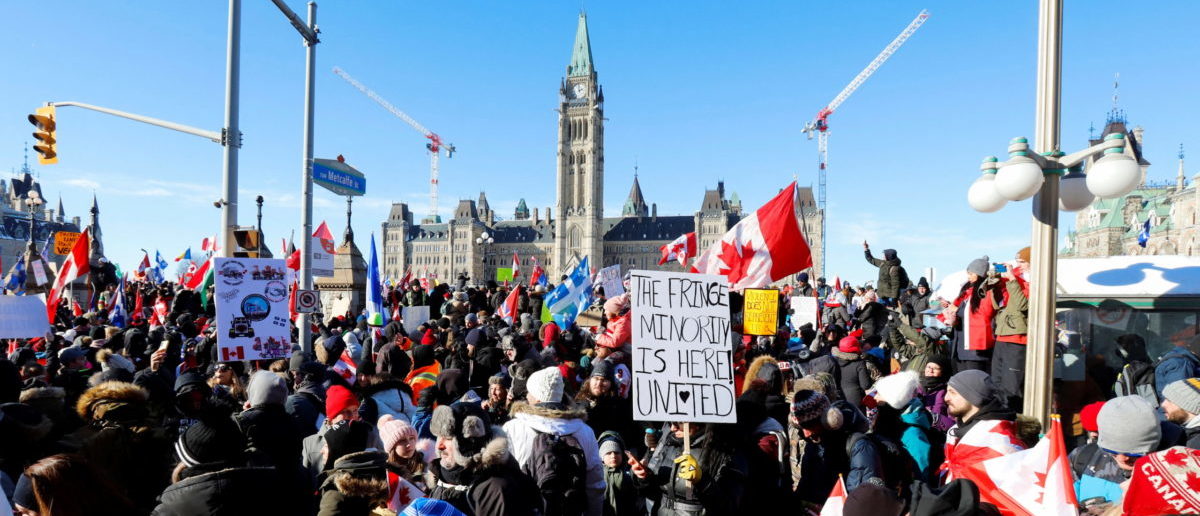Protestors gather in front of Parliament Hill as truckers and supporters take part in a convoy to protest coronavirus disease (COVID-19) vaccine mandates for cross-border truck drivers in Ottawa, Ontario, Canada, January 29, 2022. REUTERS/Patrick Doyle