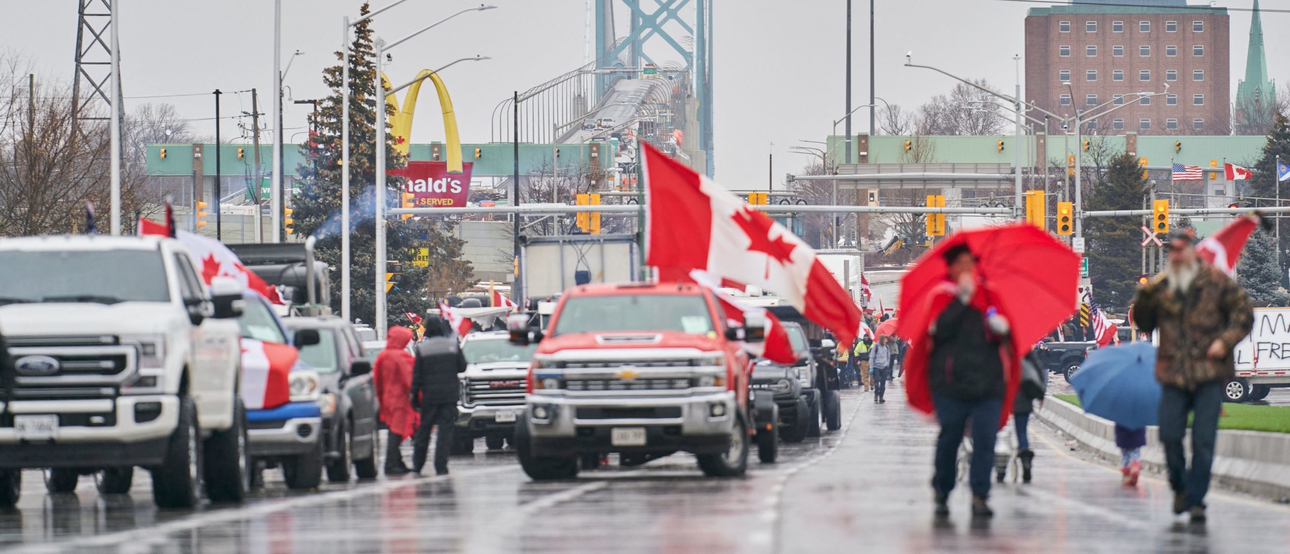 Anti-vaccine mandate protestors block the roadway at the Ambassador Bridge border crossing, in Windsor, Ontario, Canada on February 11, 2022. - The protestors who are in support of the Truckers Freedom Convoy in Ottawa have blocked traffic in the Canada bound lanes from the bridge since February 7, 2022.