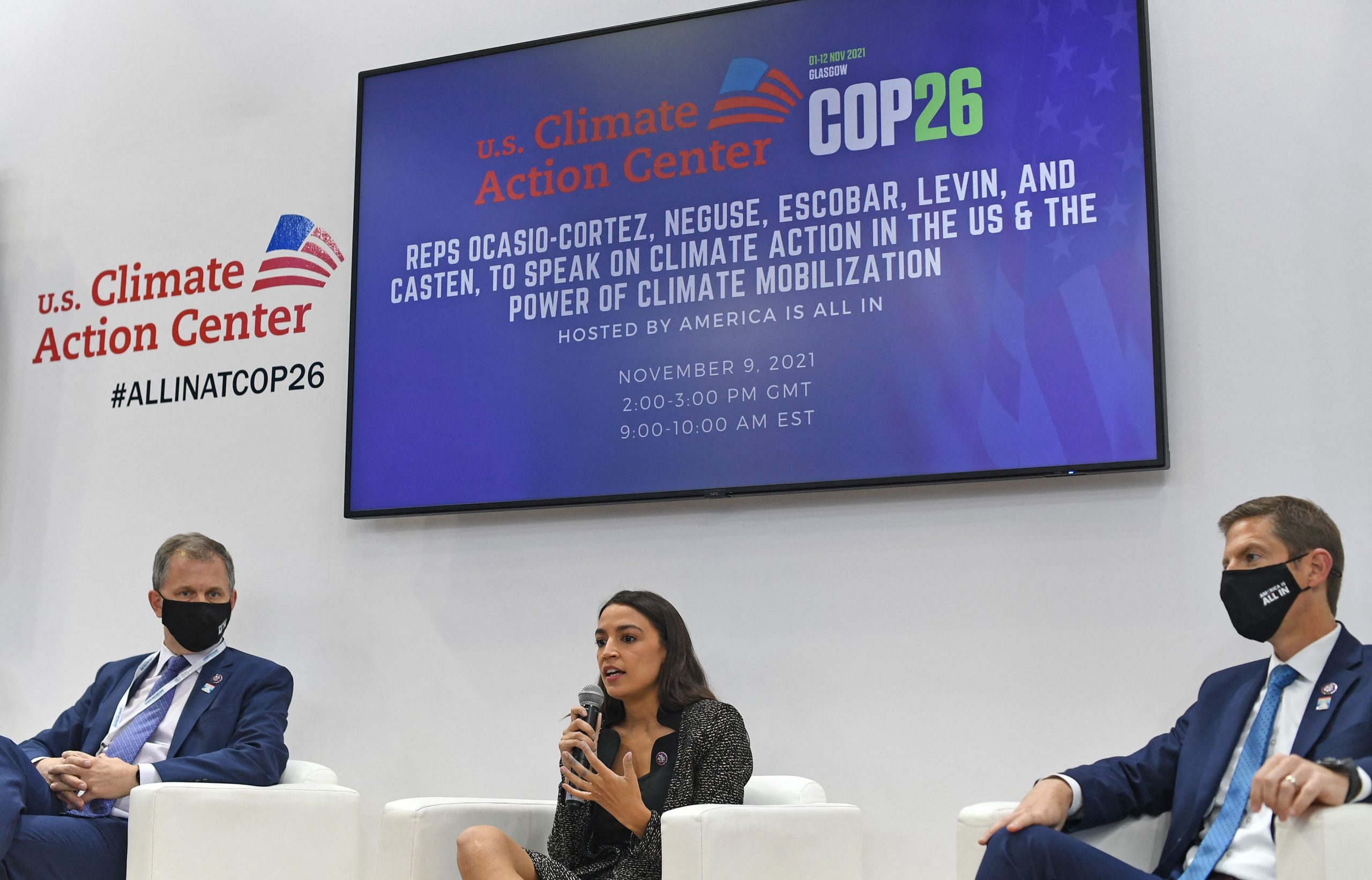 Democratic Reps. Sean Casten (left) and Mike Levin (right) look on as Rep. Alexandria Ocasio-Cortez speaks at the COP26 UN Climate Change Conference in Glasgow on Nov. 9. (Paul Ellis/AFP via Getty Images)