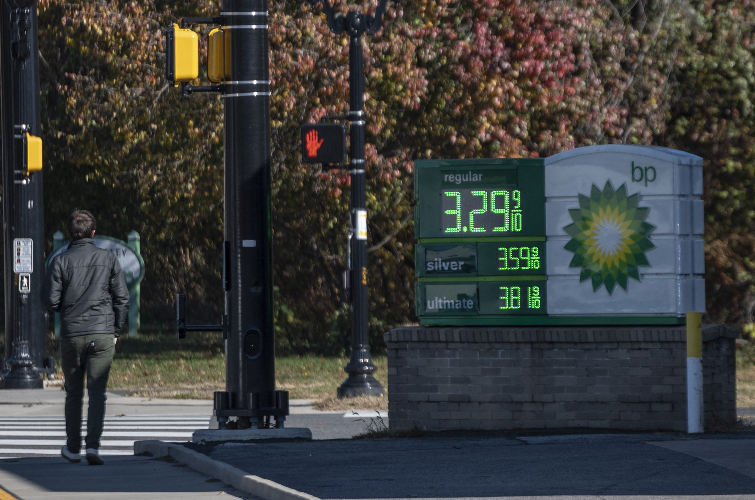A man walks past a price board at a BP gas station in Arlington, Virginia on Nov. 23. (Andrew Caballero-Reynolds/AFP via Getty Images)