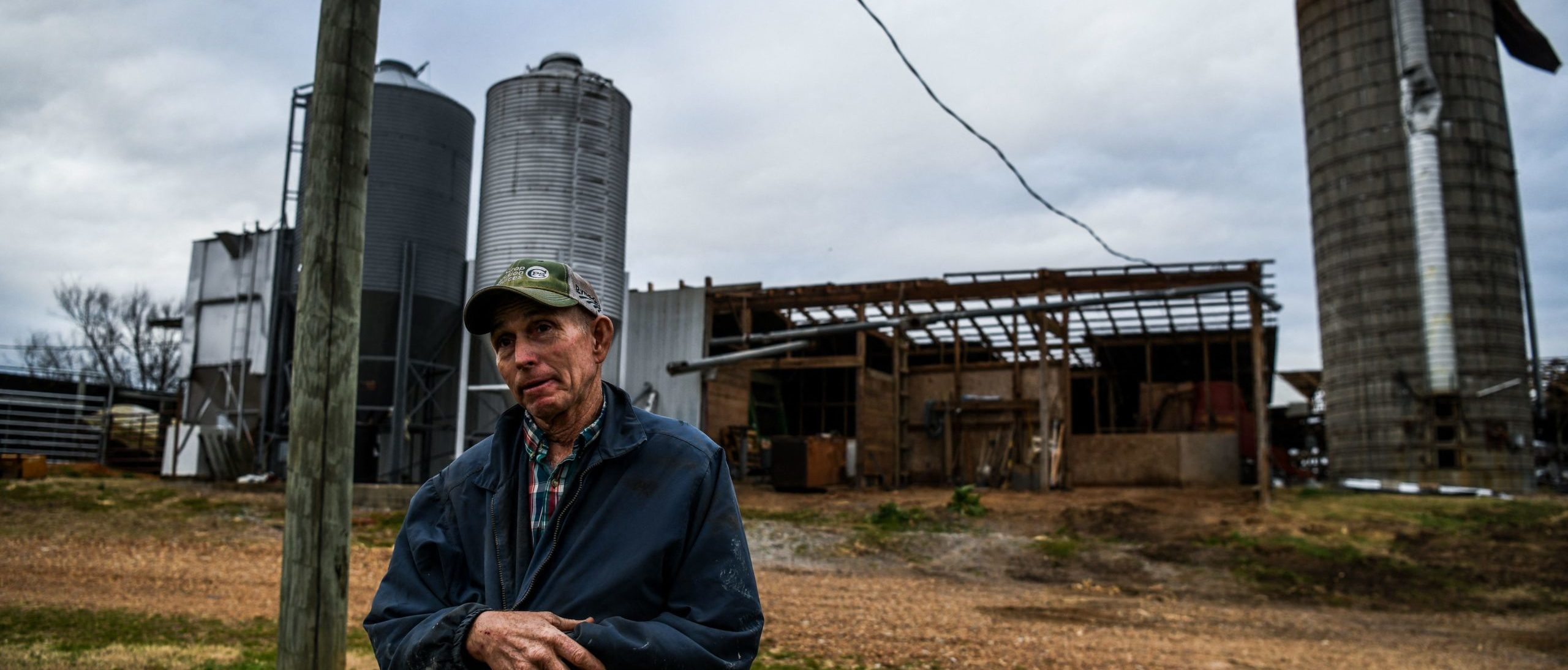 Clifford Humphreys, Jr stands outside his damaged barn in Fulgham, Kentucky, on December 15, 2021, five days after tornadoes hit the area. - Even as donations of food, blankets and clothing made their way to isolated spots, some tornado-hit rural Kentuckians -- many of whom embrace a lifestyle of self-sufficiency and independence -- said they had no interest in being bombarded with help from Washington. "Personally the less government I see the better," said Clifford Humphreys, a 65-year-old whose farm on a back road in Fulgham suffered moderate damage. (Photo by CHANDAN KHANNA / AFP) (Photo by CHANDAN KHANNA/AFP via Getty Images)