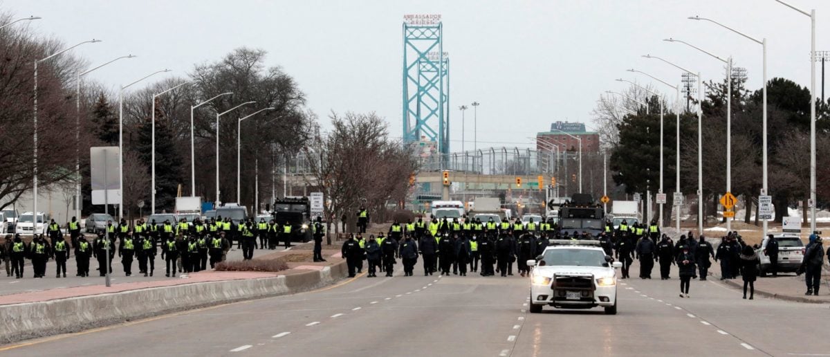 Police gather to clear protestors against Covid-19 vaccine mandates who blocked the entrance to the Ambassador Bridge in Windsor, Ontario, Canada, on February 13, 2022. (Photo by JEFF KOWALSKY/AFP via Getty Images)
