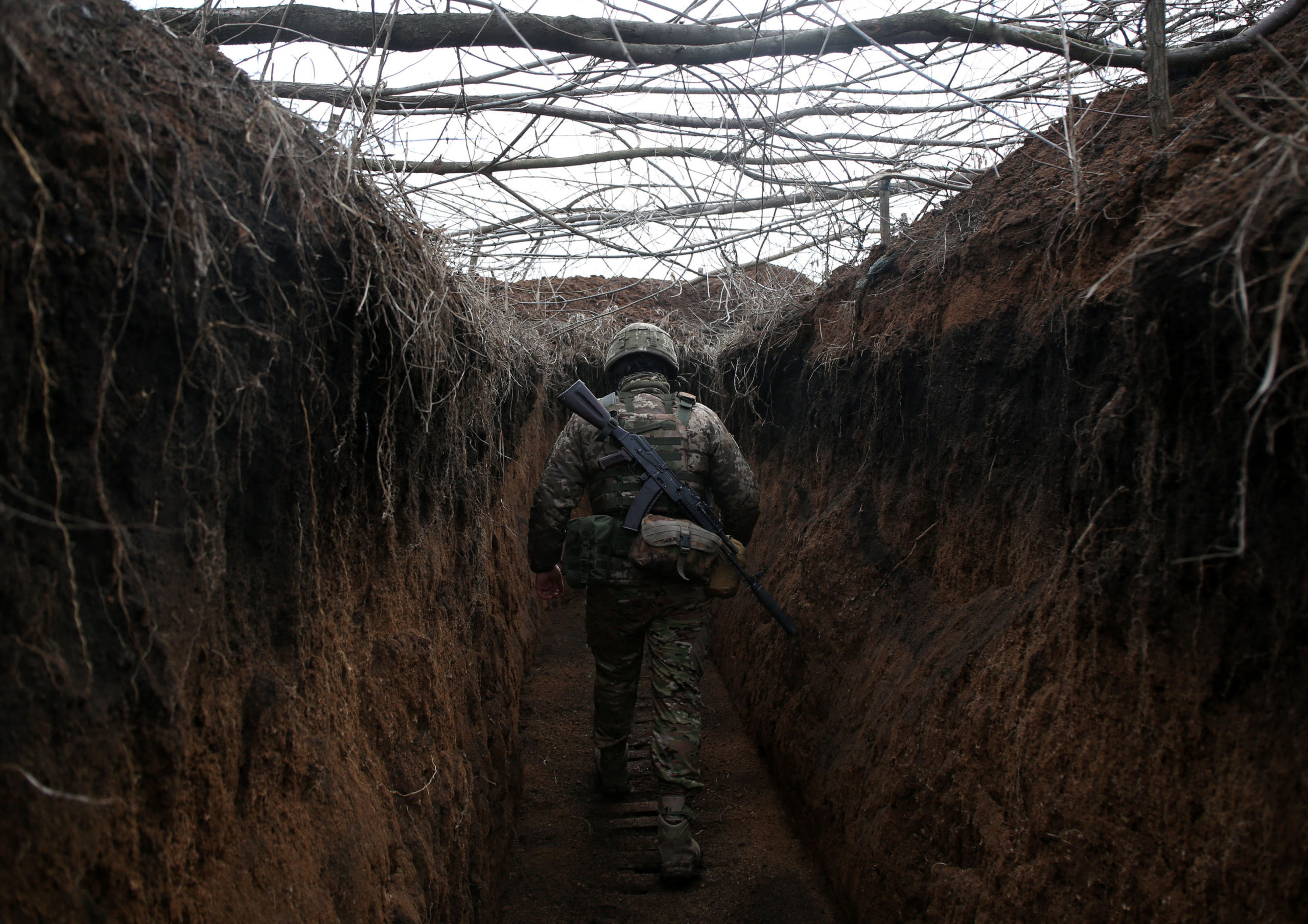TOPSHOT - A serviceman of Ukrainian Military Forces walks along trench on his position on the front line with Russia backed separatists not far Novolugansk, Donetsk region on February 16, 2022. (Photo by Anatolii STEPANOV / AFP) (Photo by ANATOLII STEPANOV/AFP via Getty Images)