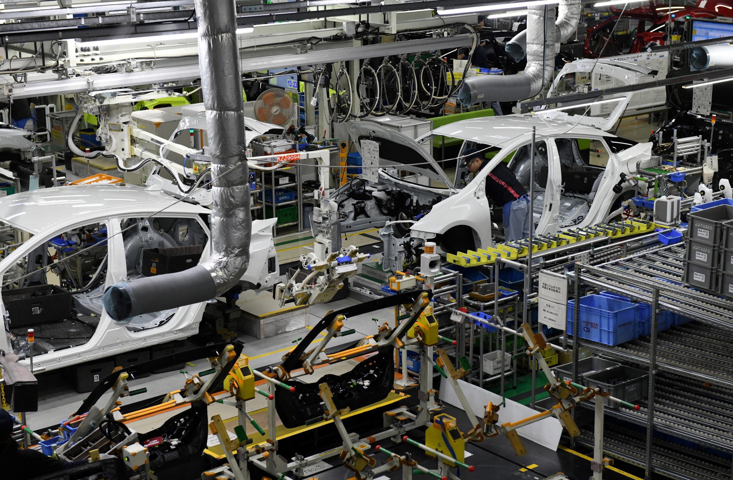 This December 8, 2017 picture shows workers assembling fourth generation Toyota Prius cars on the production line at the company's Tsutsumi assembly plant in Toyota City, Aichi prefecture. (Photo credit TOSHIFUMI KITAMURA/AFP via Getty Images)