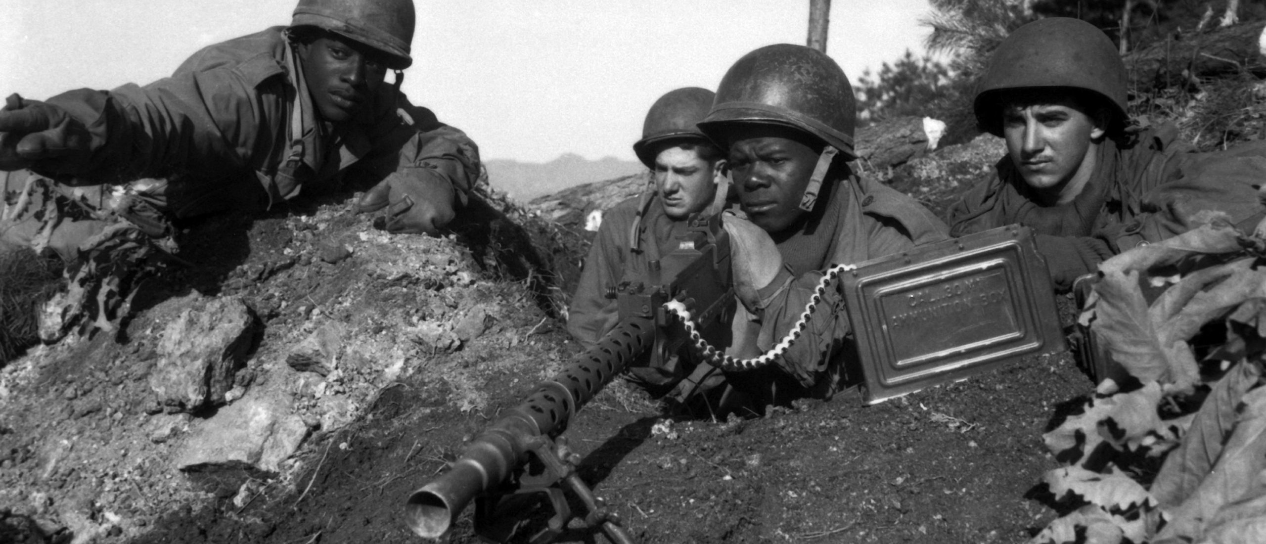 Fighting with the 2nd Infantry Division north of the Chongchon River, Sfc. Major Cleveland, points out a Communist-led North Korean position to his machine gun crew armed with a Browning M1919 machine gun on Nov. 20, 1950. [Photo courtesy of Pfc. James Cox.]