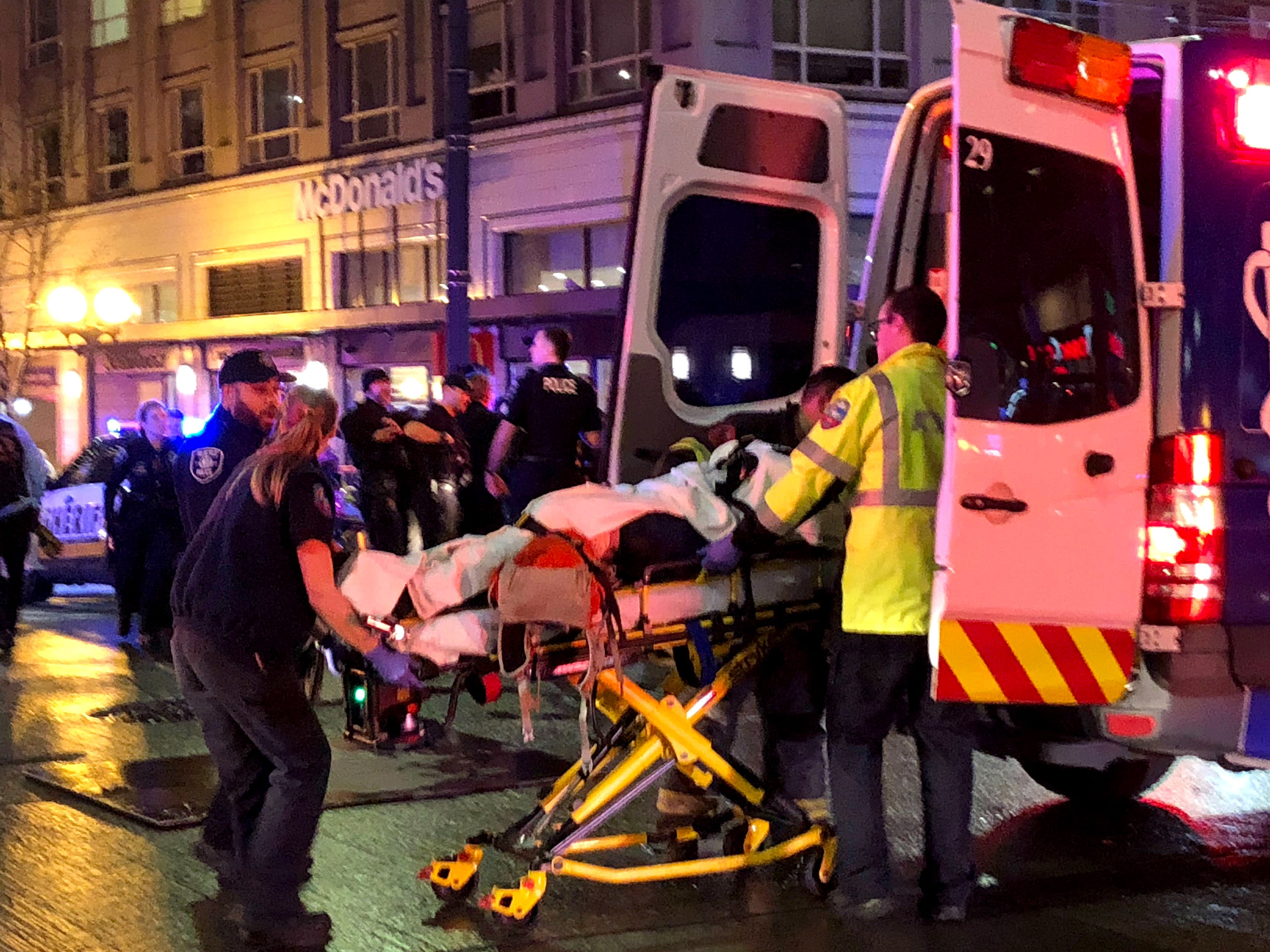 EMT and Police give first aid to a shooting victim in downtown on January 22, 2020 in Seattle, Washington. (Photo by Chris Porter/Getty Images)