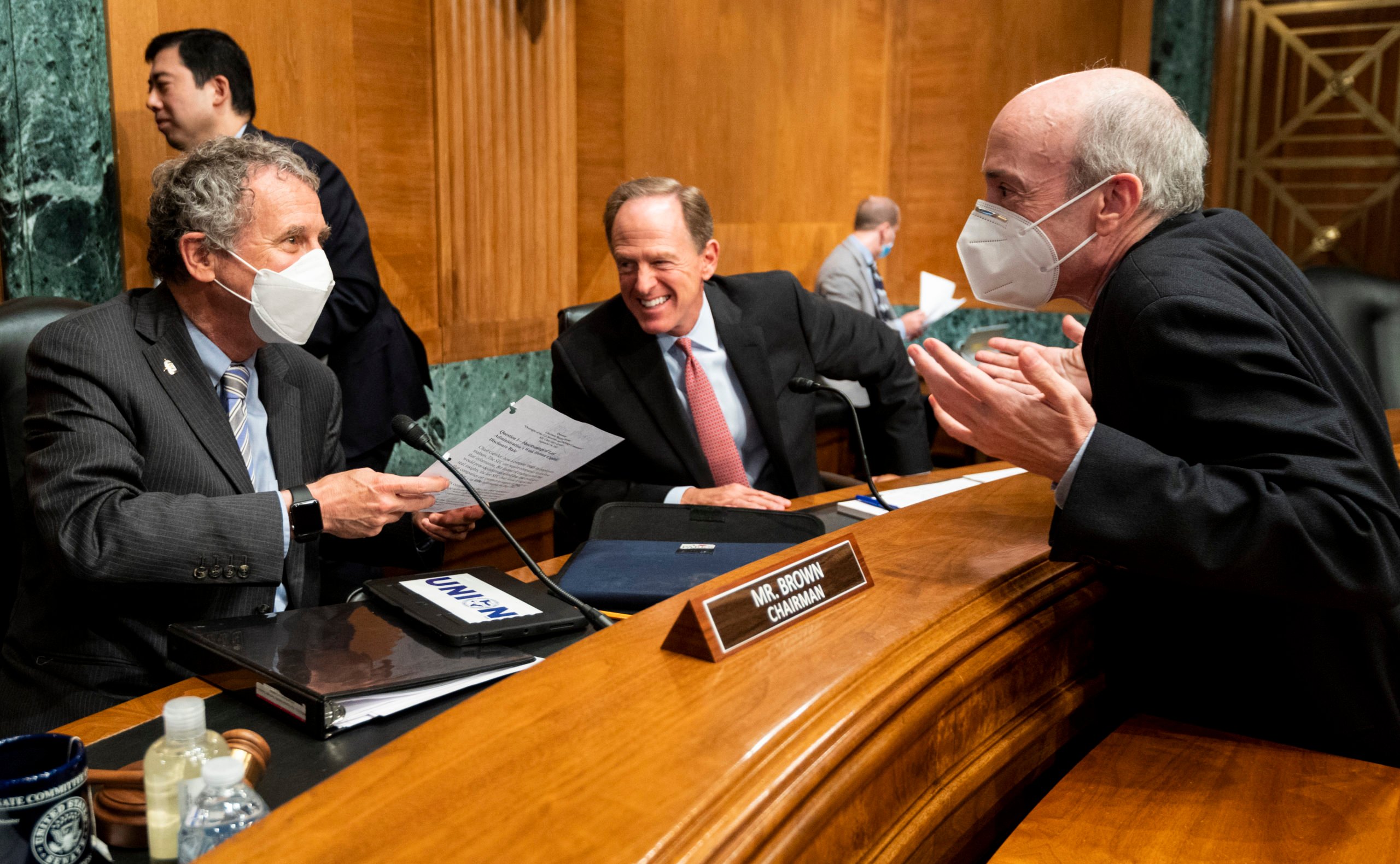 Banking Committee Chairman Sherrod Brown and Ranking Member Pat Toomey speak with SEC Chair Gary Gensler before a hearing on Sept. 14 in Washington, D.C. (Bill Clark/Pool/Getty Images)