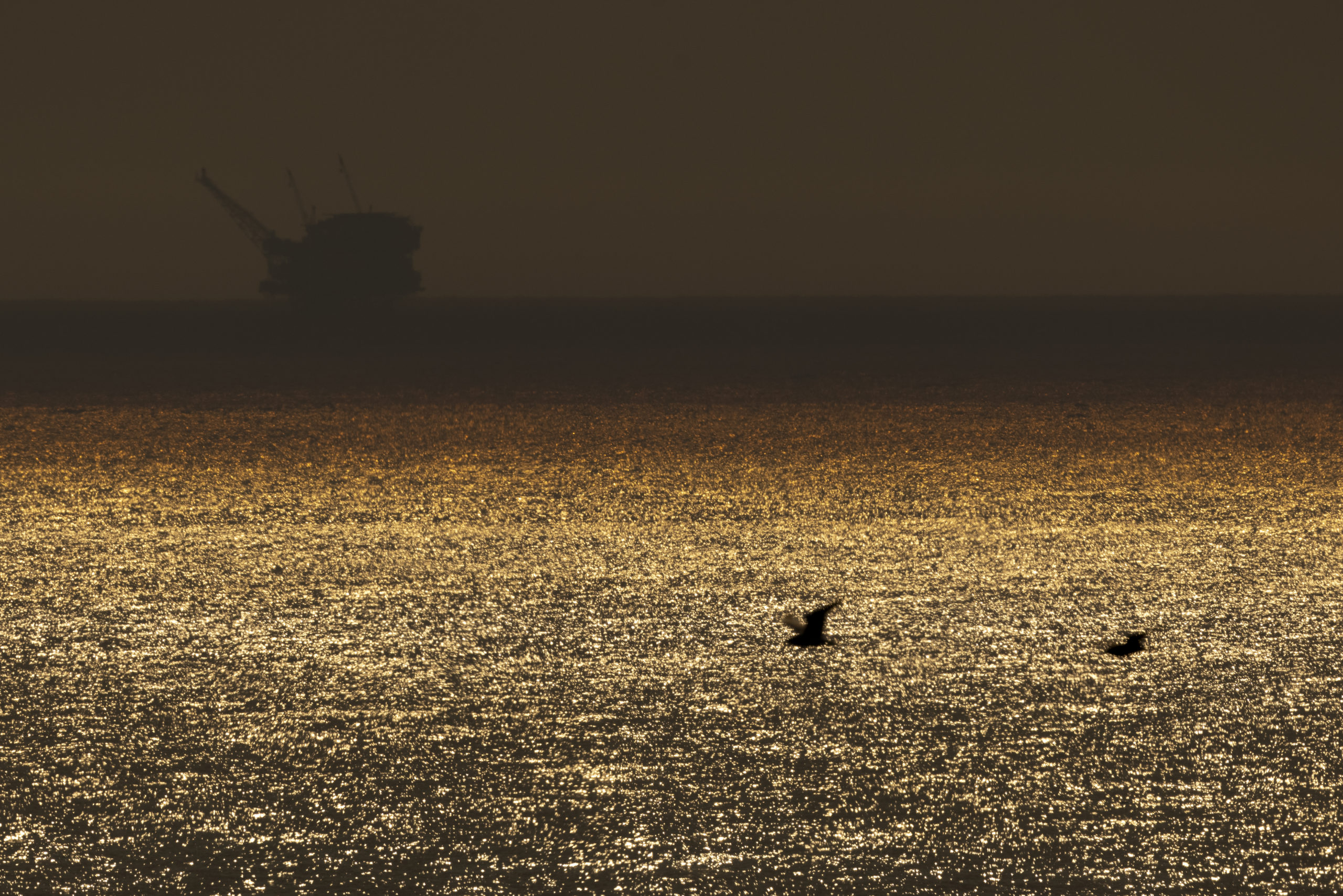An offshore oil rig is pictured in the distance on Oct. 12 near Goleta, California. (David McNew/Getty Images)