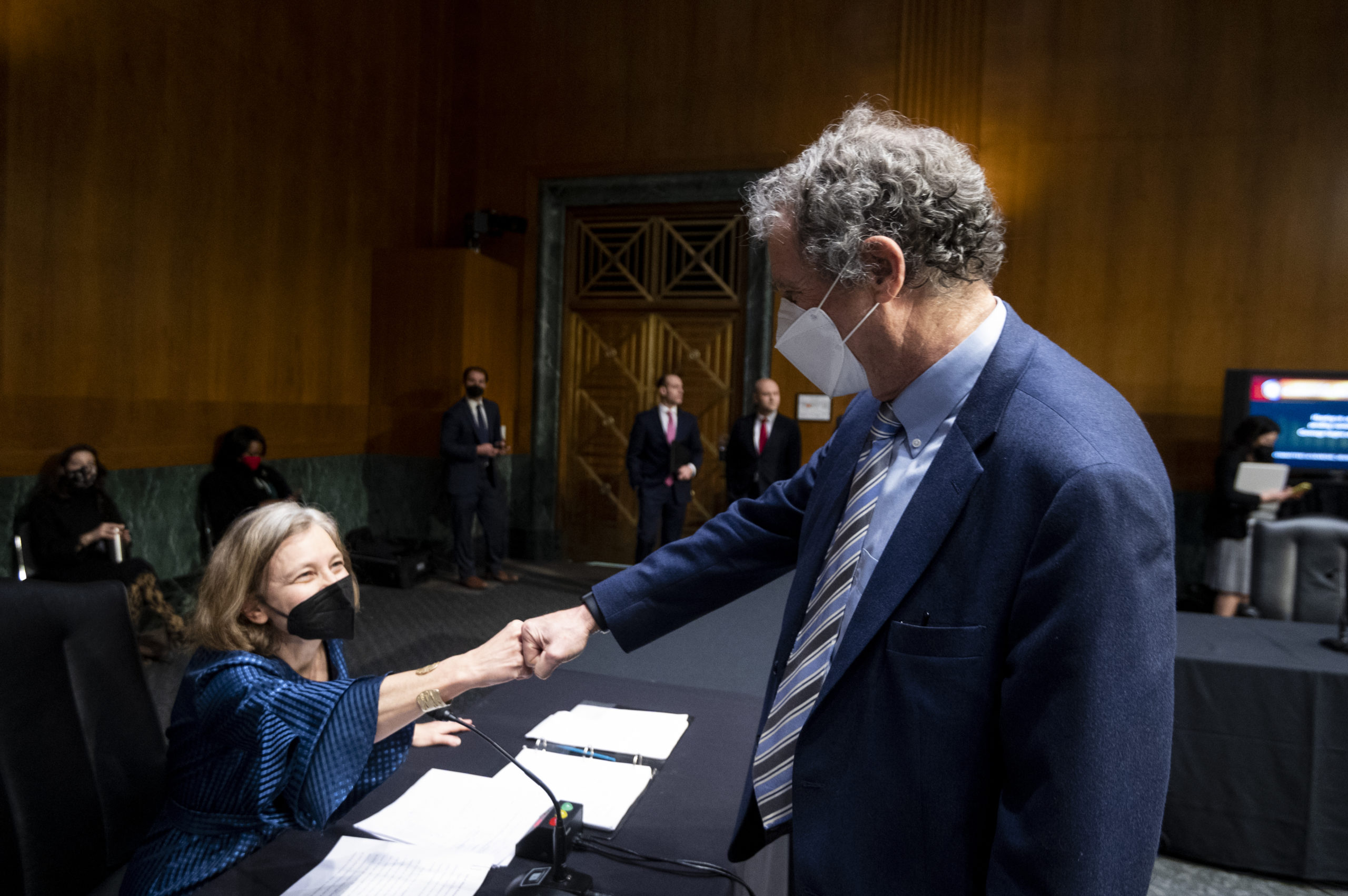 Banking Committee Chairman Sherrod Brown fist bumps Sarah Bloom Raskin before the start of her confirmation hearing on Feb. 3. (Bill Clark/Pool/Getty Images)