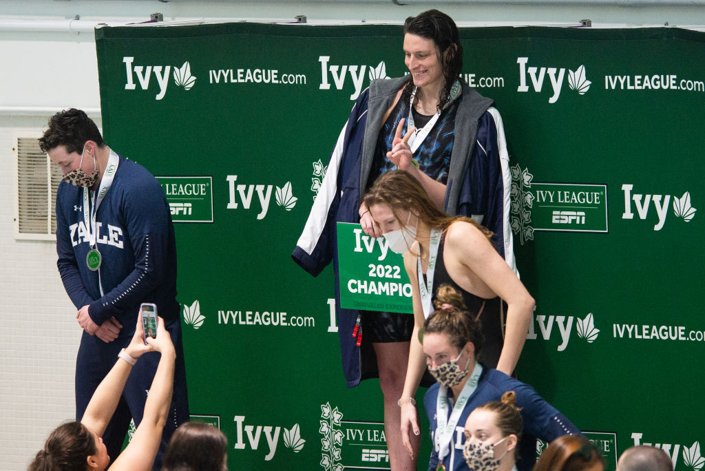 CAMBRIDGE, MA - FEBRUARY 19: University of Pennsylvania swimmer Lia Thomas (C) poses on the podium after winning the 100 yard freestyle, Yale University swimmer Iszac Henig finished (L) second, and Princeton University swimmer Nikki Venema (R) finished third during the 2022 Ivy League Womens Swimming and Diving Championships at Blodgett Pool on February 19, 2022 in Cambridge, Massachusetts. (Photo by Kathryn Riley/Getty Images)