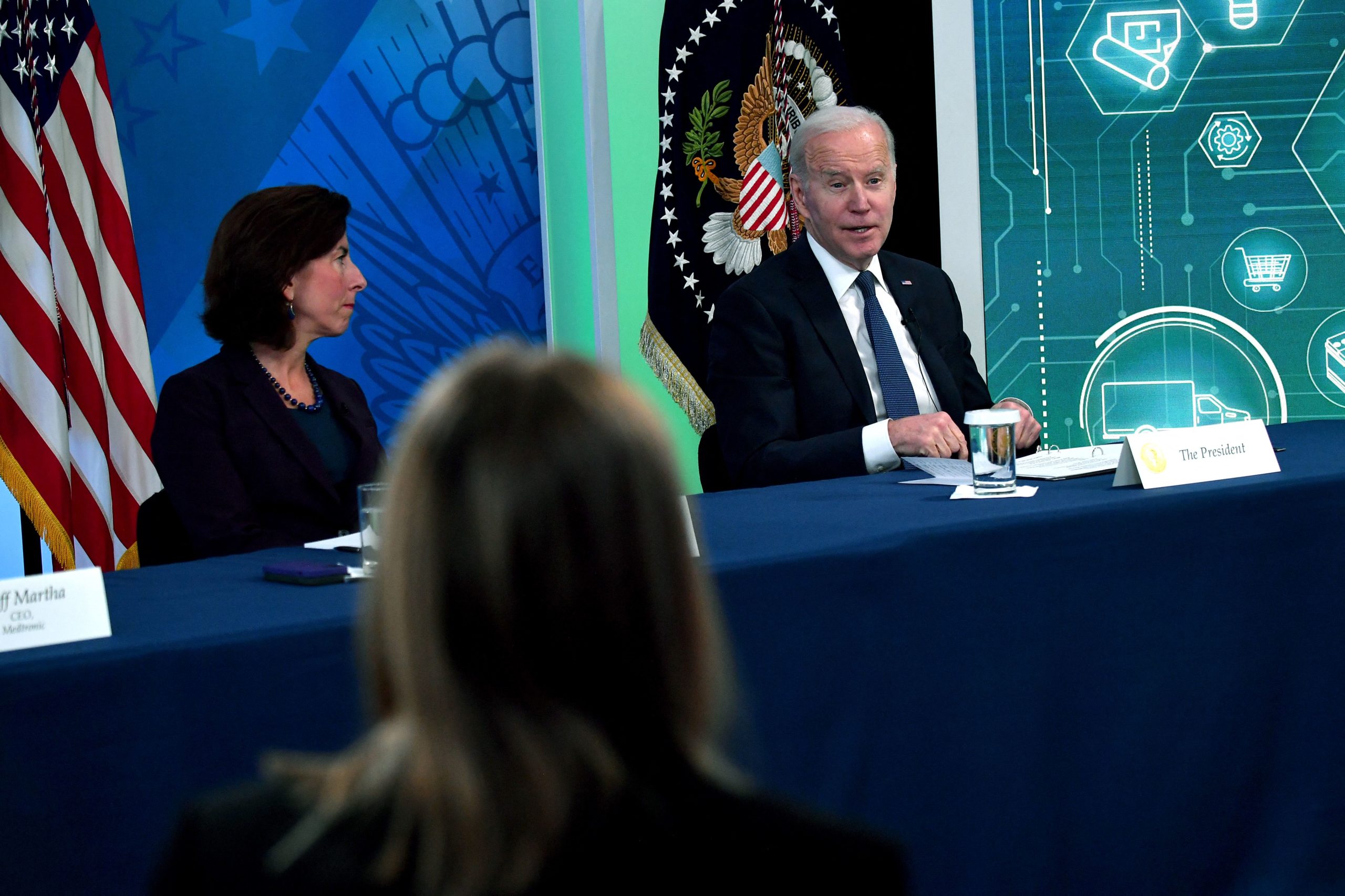 Secretary of Commerce Gina Raimondo listens as President Joe Biden speaks during a meeting with business leaders on March 9. (Nicholas Kamm/AFP via Getty Images)