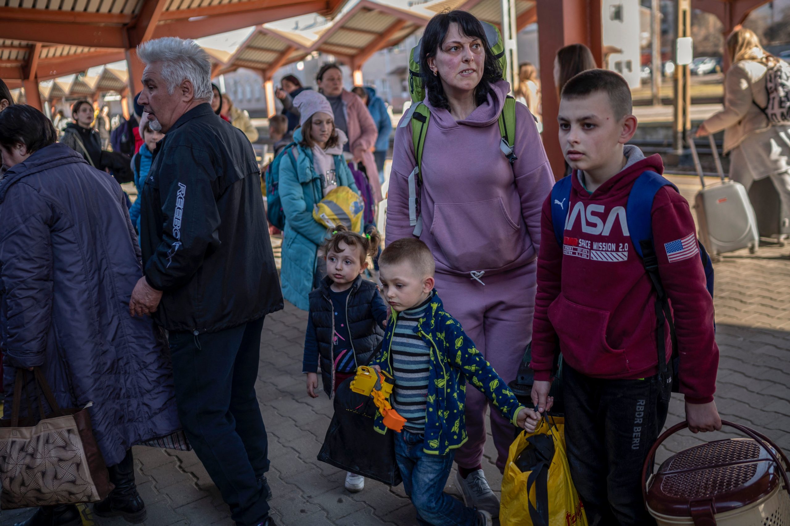 Ukrainian evacuees board a train to Warsaw at the rail station in Przemysl, near the Polish-Ukrainian border, on March 23, 2022, following Russia's military invasion launched on Ukraine. (Photo by Angelos Tzortzinis / AFP) (Photo by ANGELOS TZORTZINIS/AFP via Getty Images)