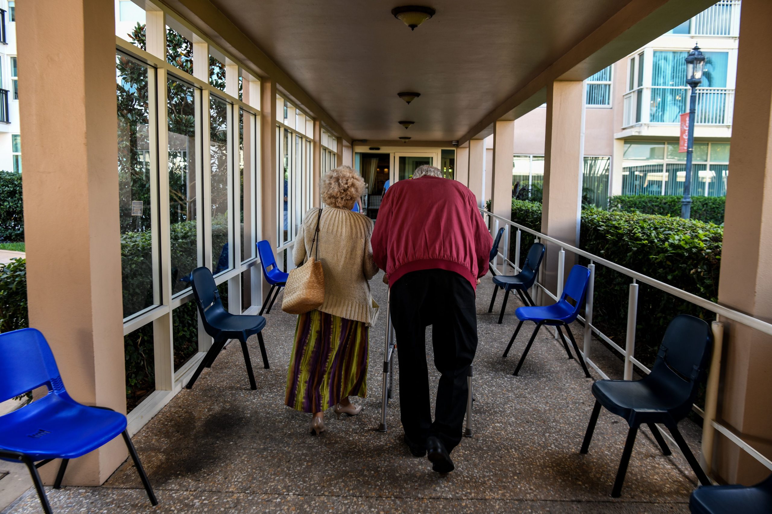 An elderly residents walks inside deserted John Knox Village, a retirement community in Pompano Beach, Florida on March 21, 2020.(Photo by CHANDAN KHANNA/AFP via Getty Images)
