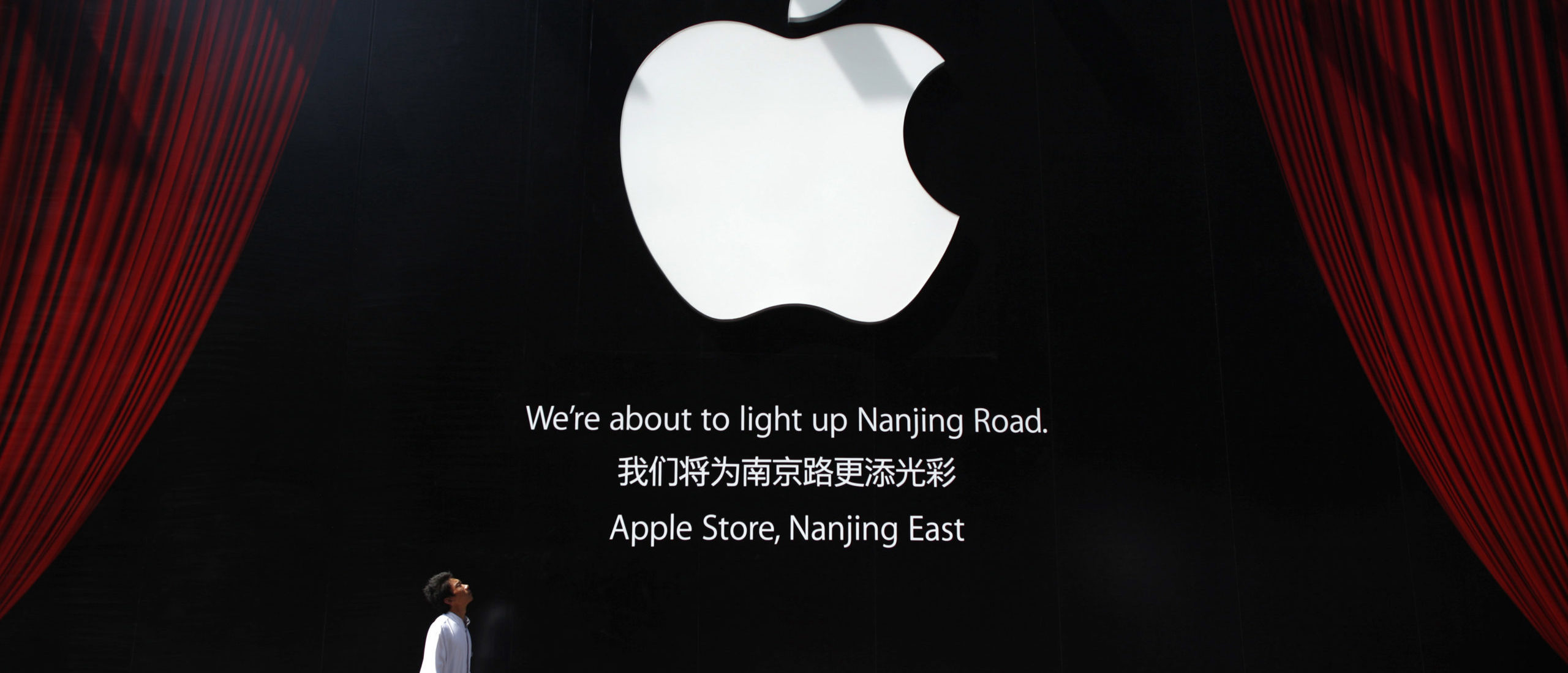 A worker walks near a sign near the third Apple Store in Shanghai September 16, 2011. (REUTERS/Aly Song) 
