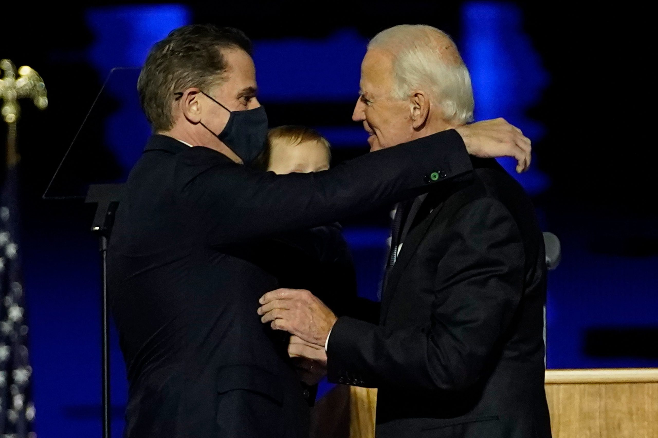 US President-elect Joe Biden (R) embraces his son Hunter Biden (L) on stage after delivering remarks in Wilmington, Delaware, on November 7, 2020. (Photo by Andrew Harnik / POOL / AFP) (Photo by ANDREW HARNIK/POOL/AFP via Getty Images)
