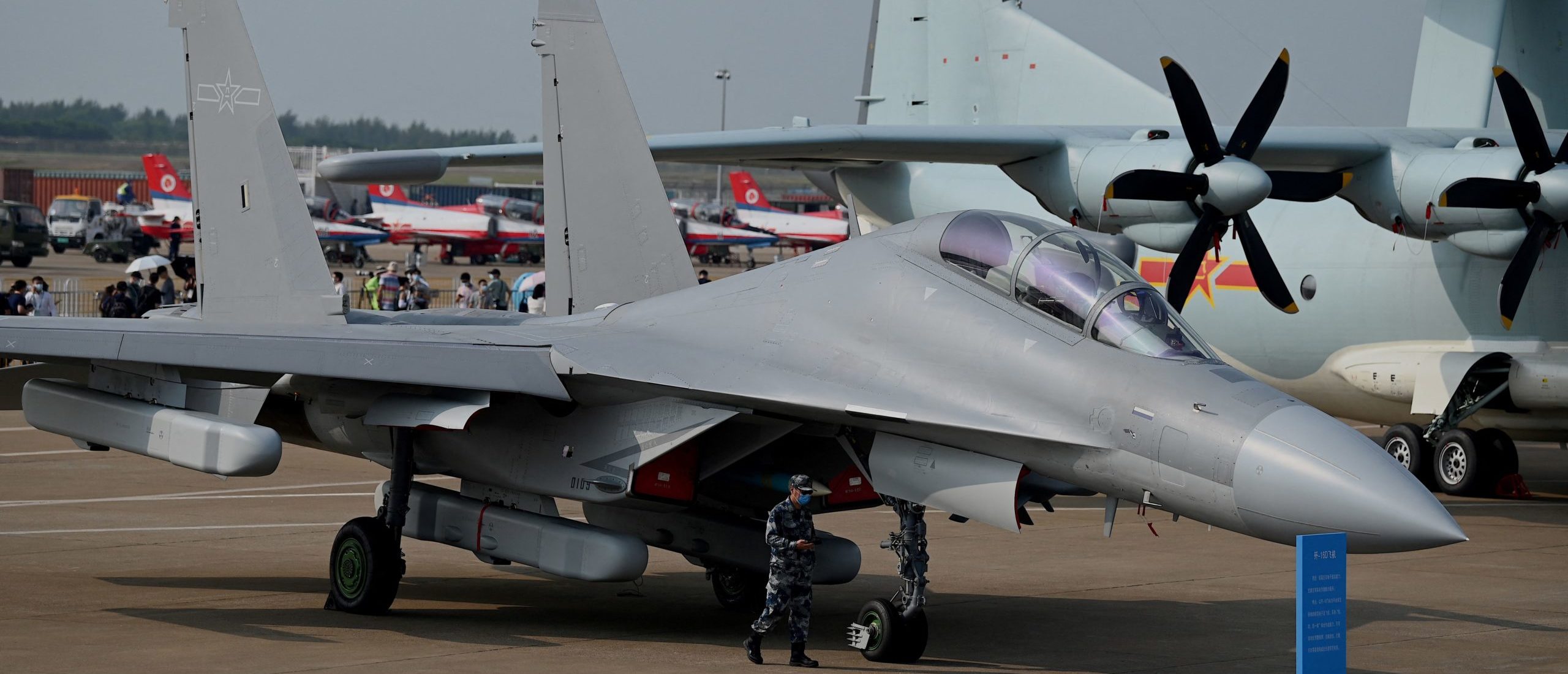 A military personnel walks past Shenyang Aircraft Corporation's J-16 multirole strike fighter for the People's Liberation Army Air Force (PLAAF) at the 13th China International Aviation and Aerospace Exhibition in Zhuhai in southern China's Guangdong province on September 28, 2021. (Photo by Noel Celis / AFP) (Photo by NOEL CELIS/AFP via Getty Images)