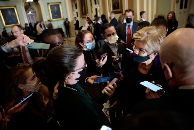 WASHINGTON, DC - DECEMBER 07: U.S. Sen. Elizabeth Warren (D-MA) speaks to reporters as she walks to a vote in the Senate Chambers of the Capitol on December 07, 2021 in Washington, DC. During a policy luncheon news conference, Senate Majority Leader Chuck Schumer (D-NY) spoke on the progress made in negotiations with Senate Minority Leader Mitch McConnell (R-KY) to vote on legislation to lift the debt ceiling. (Photo by Anna Moneymaker/Getty Images)