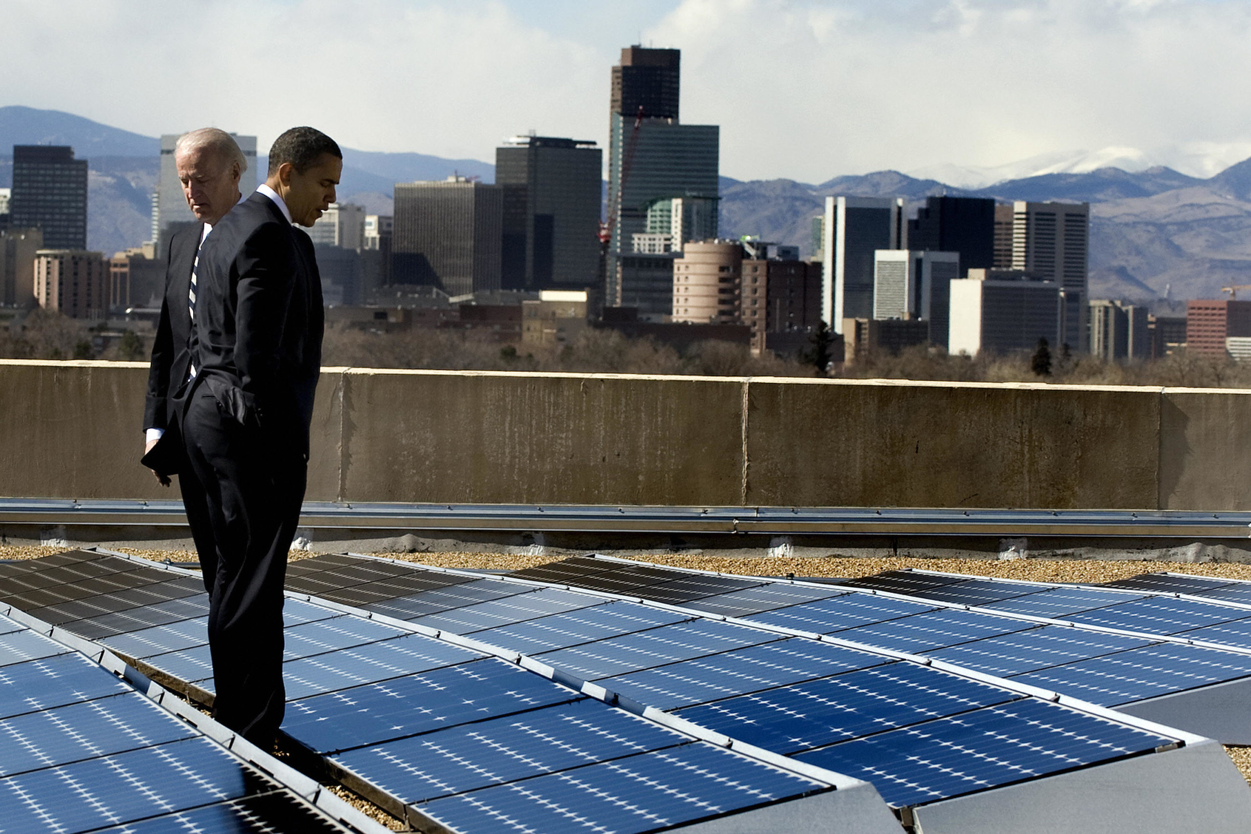 Former President Barack Obama and then-Vice President Joe Biden look at solar panels at the Denver Museum of Nature and Science in Denver, Colorado, on Feb. 17, 2009. (Jim Watson/AFP via Getty Images)