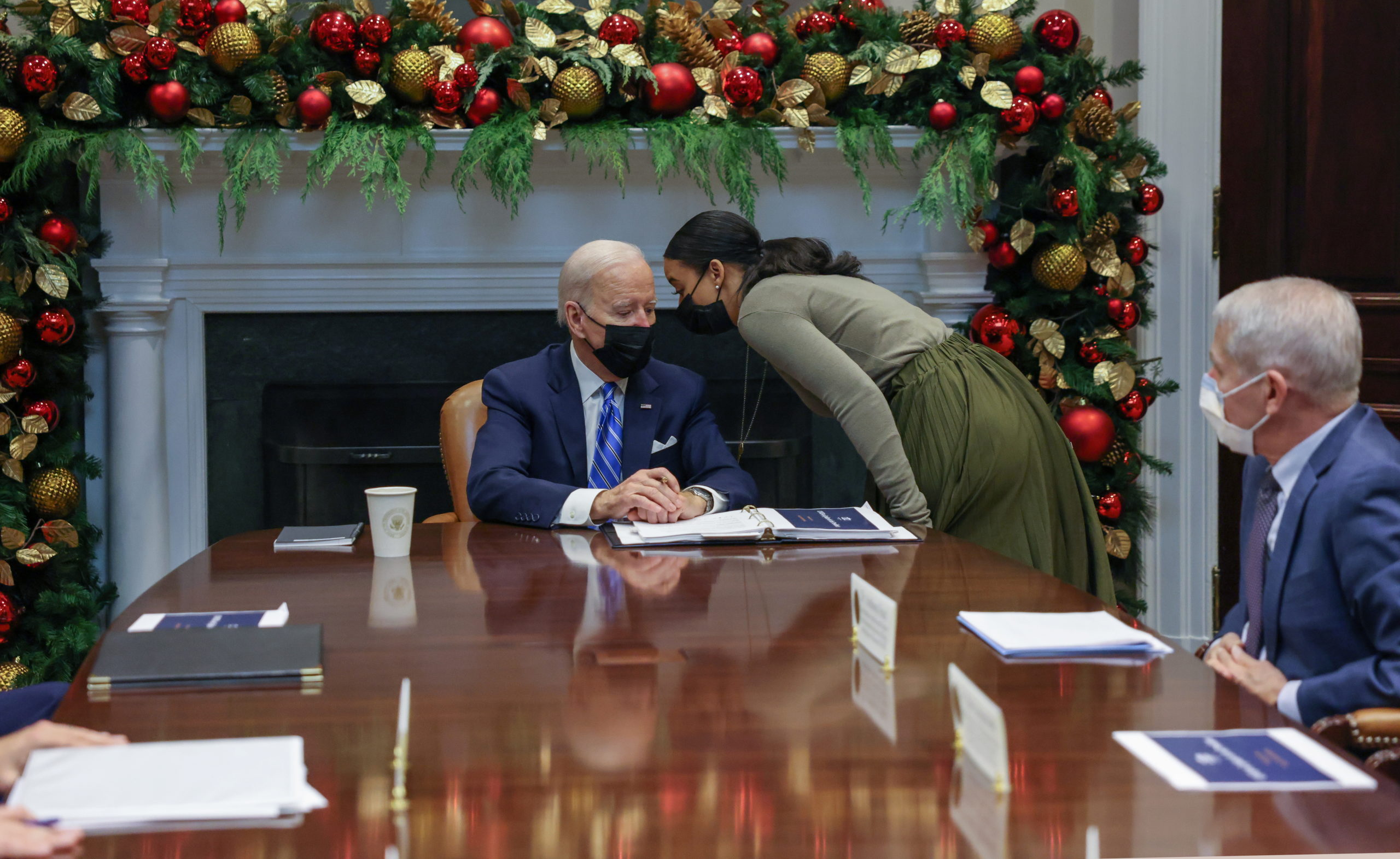 U.S. President Joe Biden gets a message from an aide during a meeting with his White House COVID-19 Response Team on the latest developments related to the Omicron variant in the Roosevelt Room in the White House in Washington, U.S., December 16, 2021. REUTERS/Evelyn Hockstein
