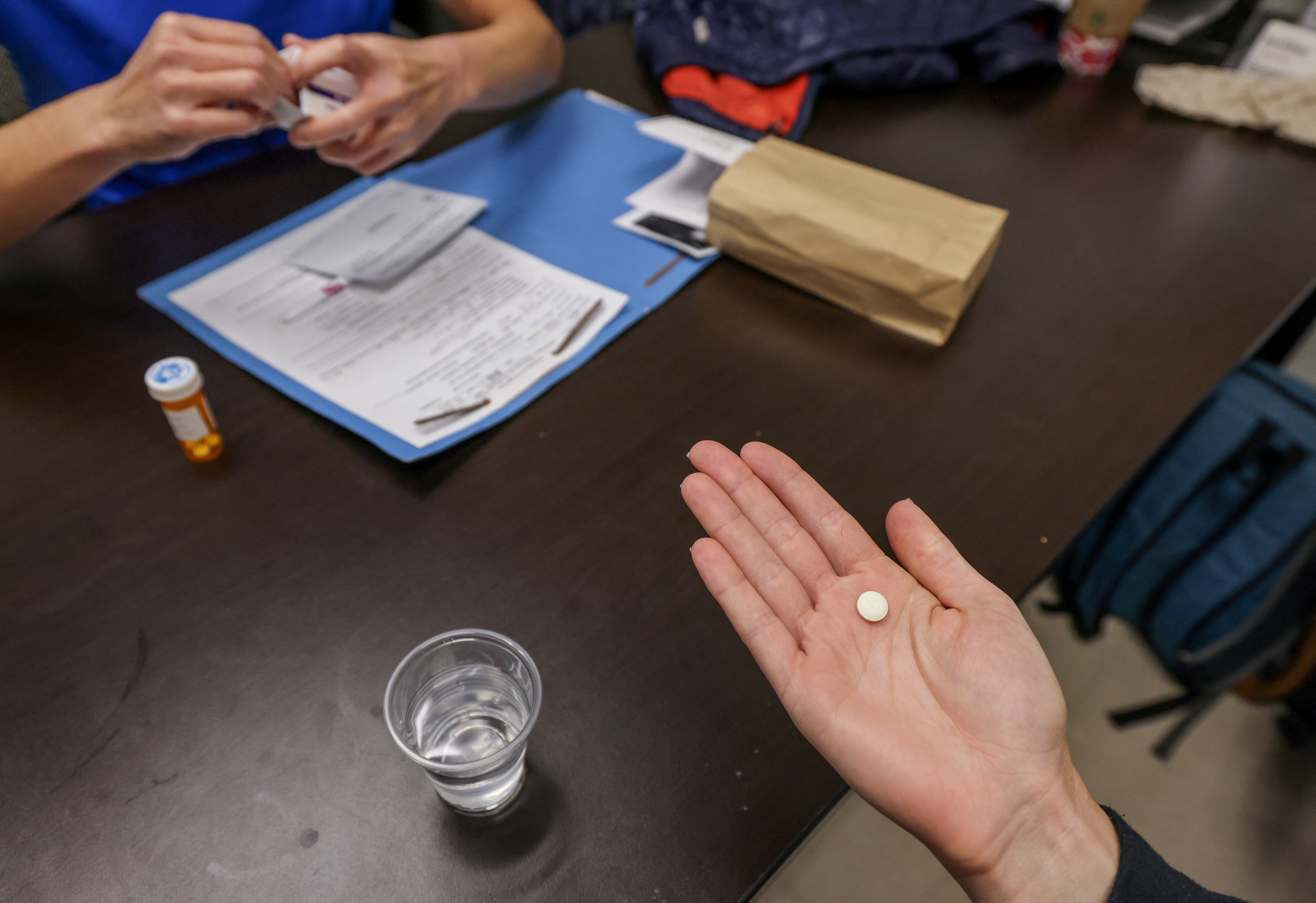 Dr. Shelly Tien hands a patient the initial abortion inducing medication at Trust Women clinic in Oklahoma City, U.S., December 6, 2021.