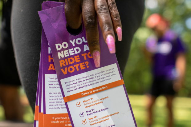 A member of the New Georgia Project carries informative paperwork before heading out to knock on doors as they canvas to encourage people to register to vote in Atlanta, Georgia, U.S., May 12, 2022. Picture taken May 12, 2022. REUTERS/Alyssa Pointer