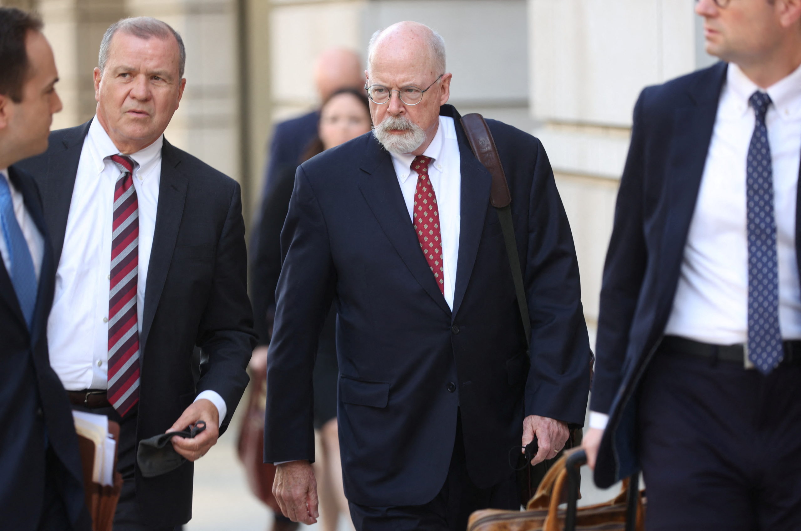 Special Counsel John Durham departs the U.S. Federal Courthouse with prosecutors and staff after opening arguments in the trial of Attorney Michael Sussmann, where Durham is prosecuting Sussmann on charges that Sussmann lied to the Federal Bureau of Investigation (FBI) while providing information about later discredited allegations of communications between the 2016 presidential campaign of former U.S. President Donald Trump and Russia, in Washington, U.S. May 17, 2022. REUTERS/Julia Nikhinson