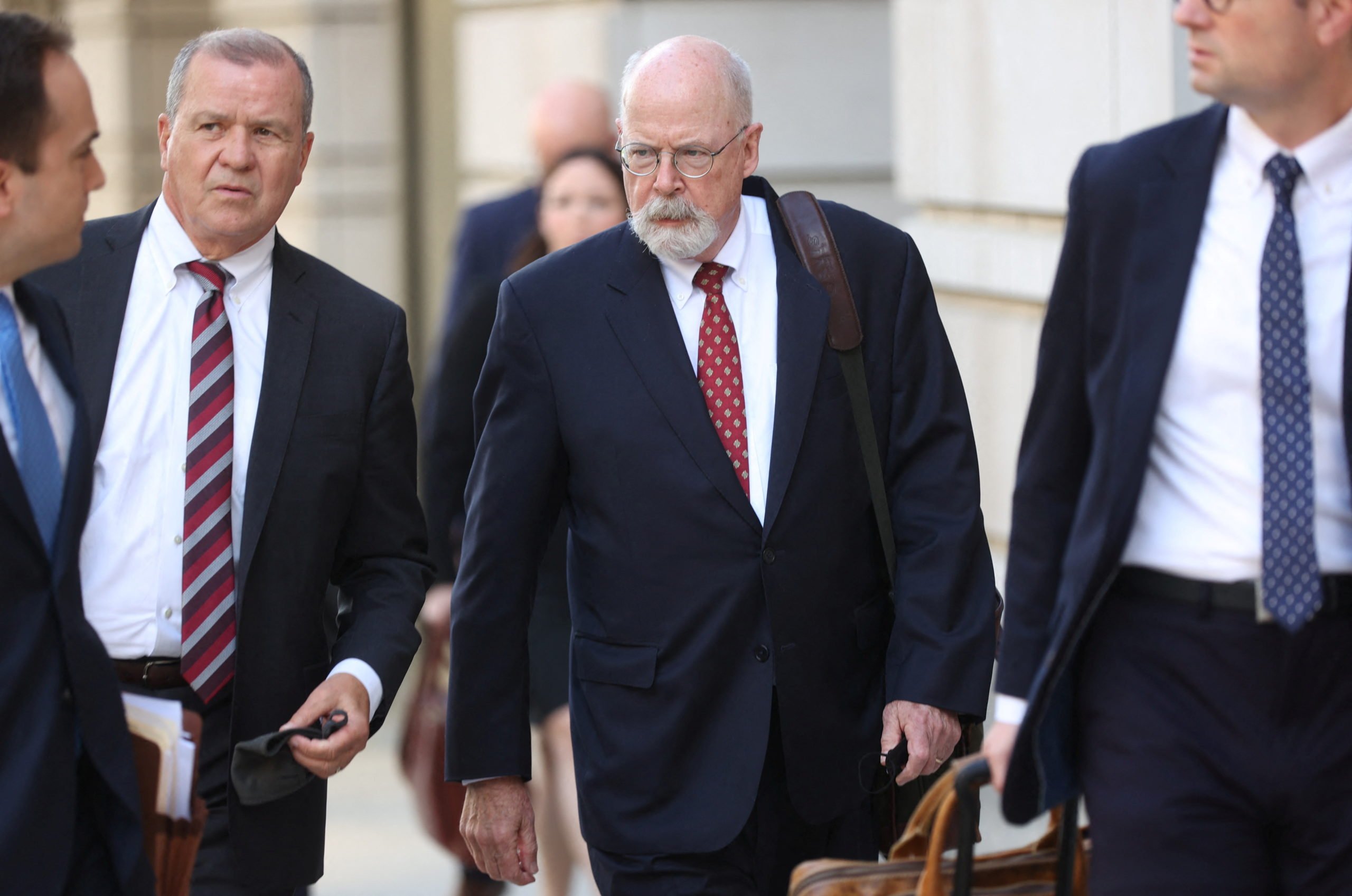 Special Counsel John Durham departs the U.S. Federal Courthouse with prosecutors and staff after opening arguments in the trial of Attorney Michael Sussmann, where Durham is prosecuting Sussmann on charges that Sussmann lied to the Federal Bureau of Investigation (FBI) while providing information about later discredited allegations of communications between the 2016 presidential campaign of former U.S. President Donald Trump and Russia, in Washington, U.S. May 17, 2022. REUTERS/Julia Nikhinson