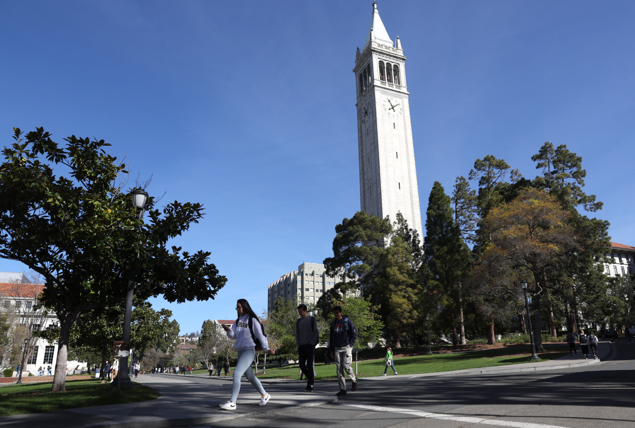 BERKELEY, CALIFORNIA - MARCH 14: People walk by Sather Tower on the UC Berkeley campus on March 14, 2022 in Berkeley, California. UC Berkeley is set to cut on-campus enrollment by a minimum of 2,500 students for fall enrollment due to an extreme shortage of affordable housing. Many college towns in California are facing similar shortages due to construction restraints. (Photo by Justin Sullivan/Getty Images)