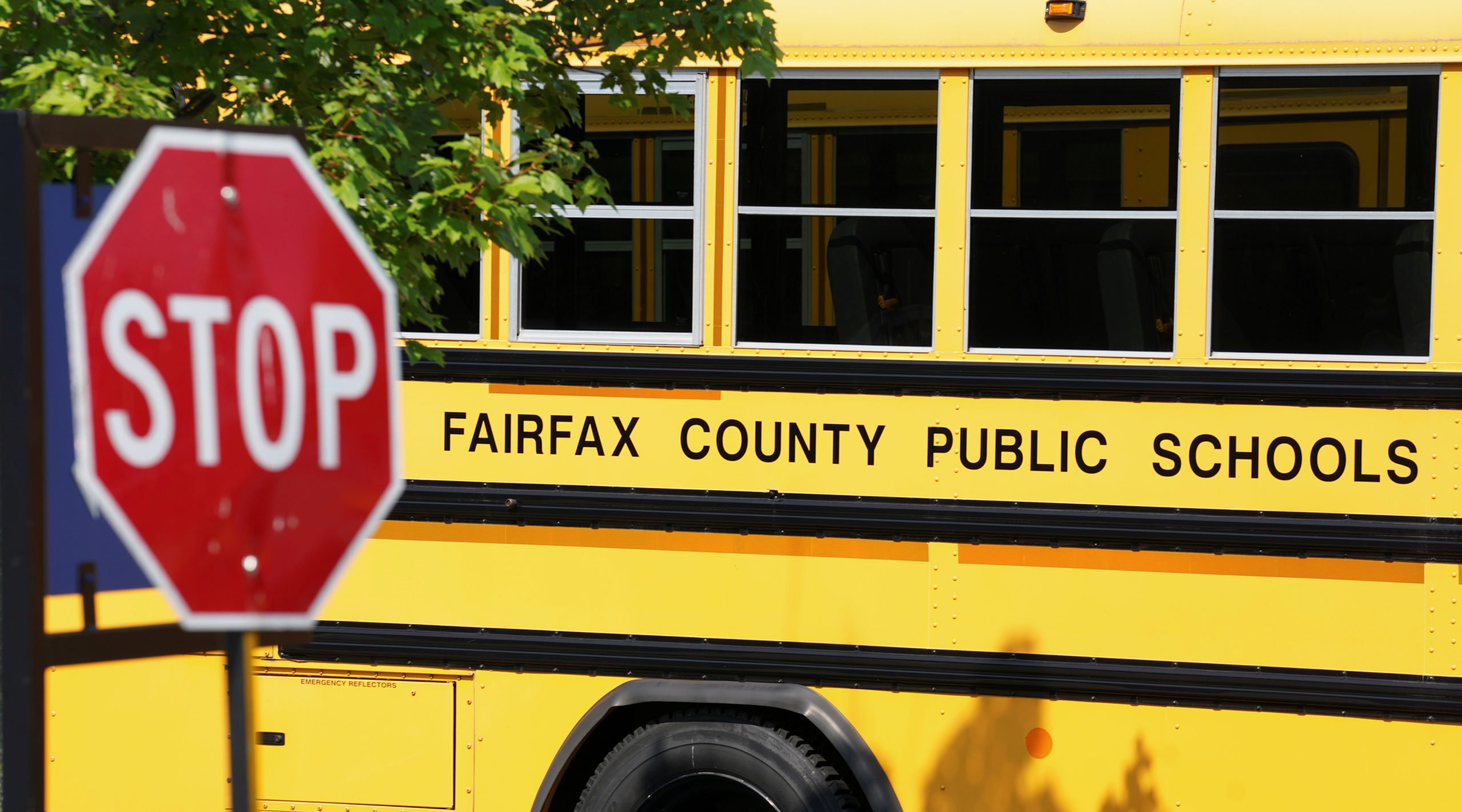A Fairfax County school bus sits in a depot, a day after it was announced the county would begin the school year all online, in Lorton, Virginia, U.S., July 22, 2020. REUTERS/Kevin Lamarque