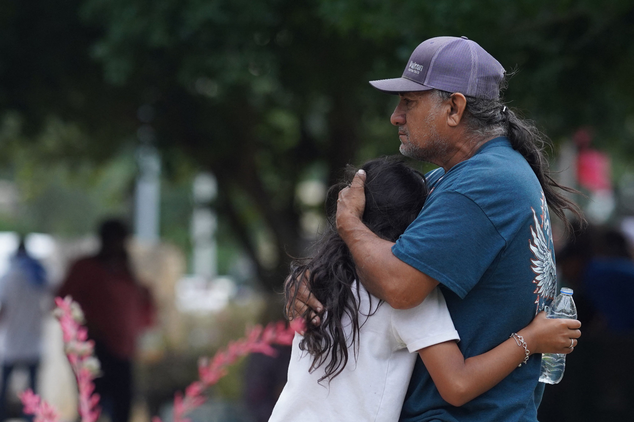 Families hug outside the Willie de Leon Civic Center where grief counseling will be offered in Uvalde, Texas, on May 24, 2022. - A teenage gunman killed 18 young children in a shooting at an elementary school in Texas on Tuesday, in the deadliest US school shooting in years. The attack in Uvalde, Texas -- a small community about an hour from the Mexican border -- is the latest in a spree of deadly shootings in America, where horror at the cycle of gun violence has failed to spur action to end it. (Photo by ALLISON DINNER/AFP via Getty Images)